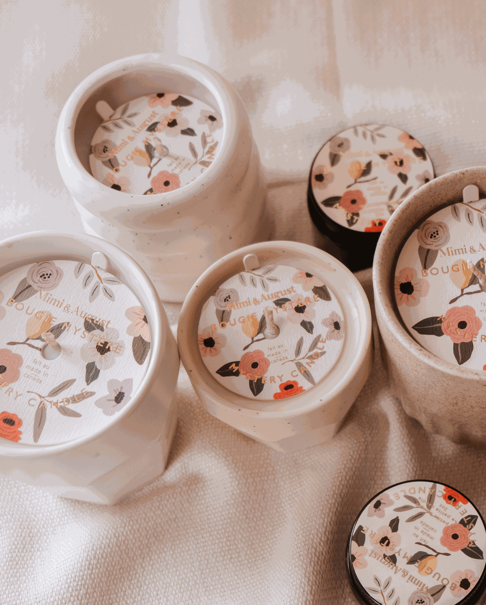 A set of Mystery Candles by Mimi & August, with enchanting floral designs, available in limited quantity.