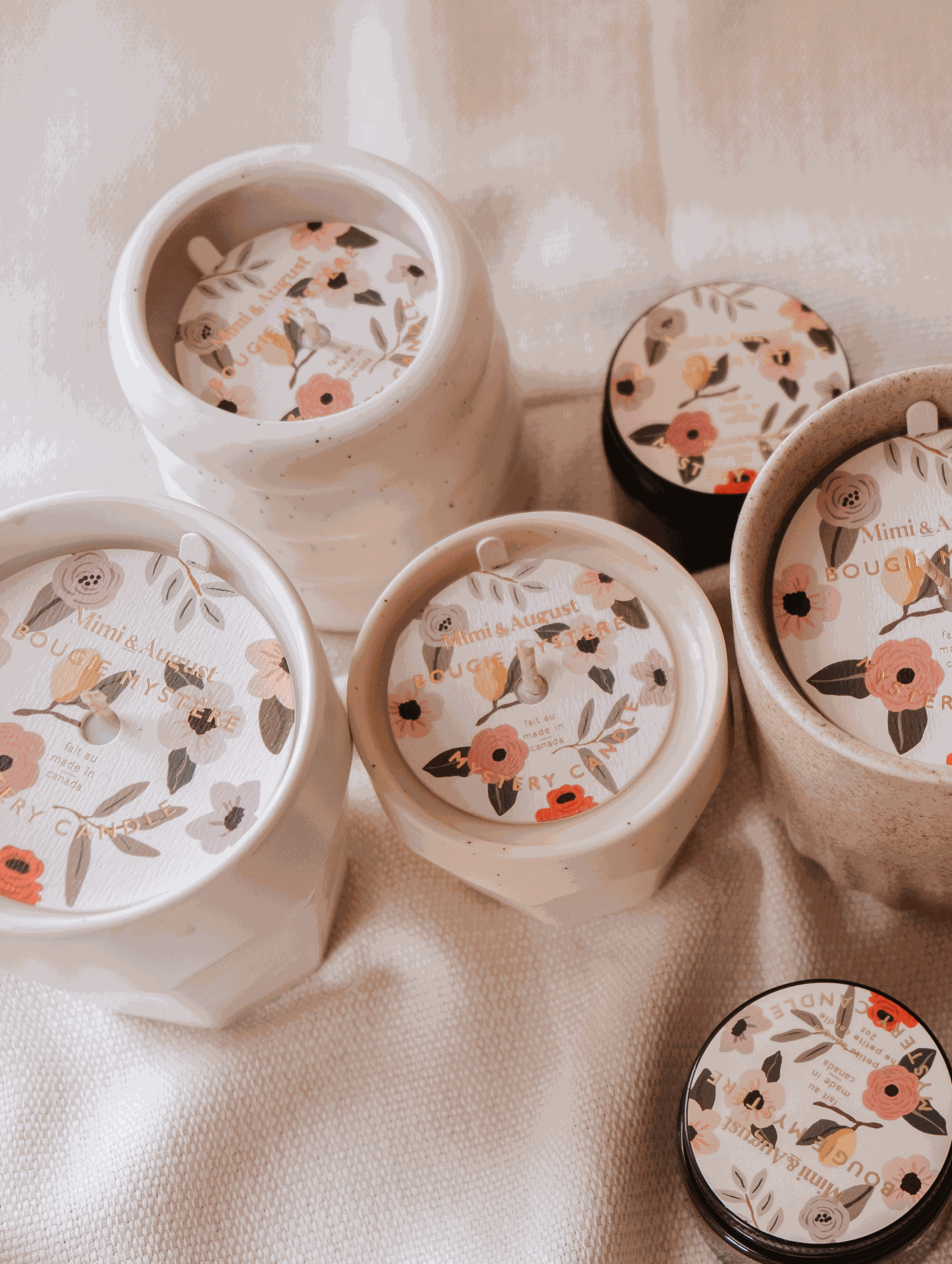 A set of Mystery Candles by Mimi & August, with enchanting floral designs, available in limited quantity.