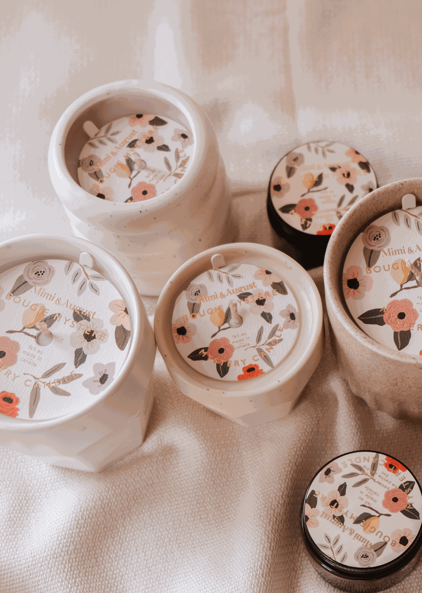 A set of Mystery Candles by Mimi & August, with enchanting floral designs, available in limited quantity.