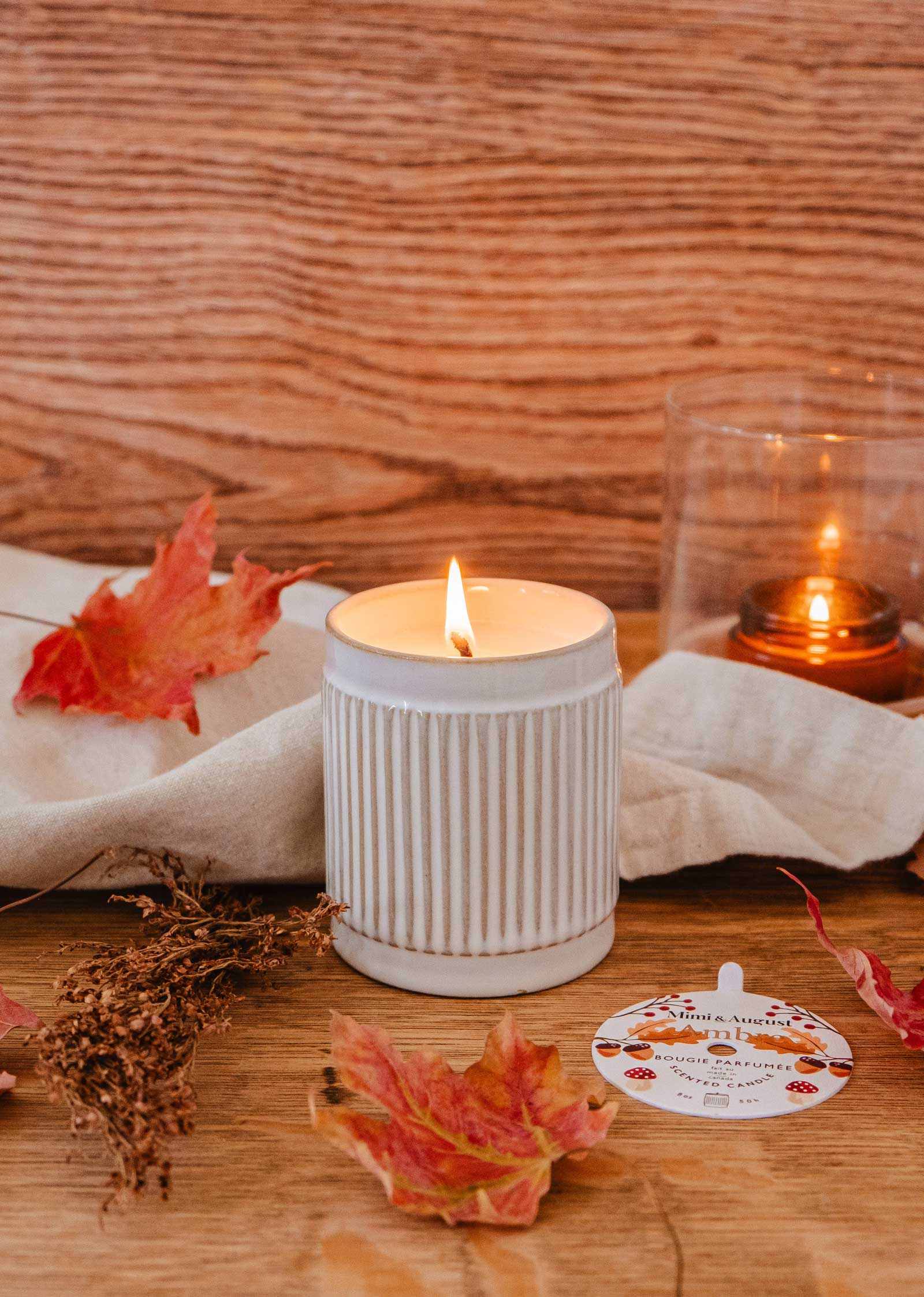 Ambre amber candle by Mimi & August with fig and cedar scent in a ceramic container.
