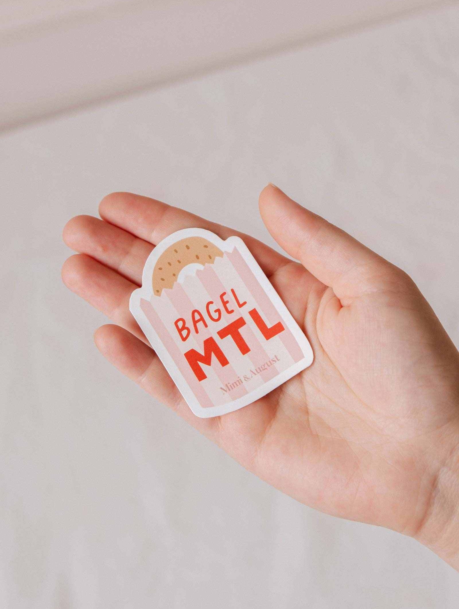 Bagel MTL vinyl sticker with playful Montréal bagel design, durable and weatherproof.