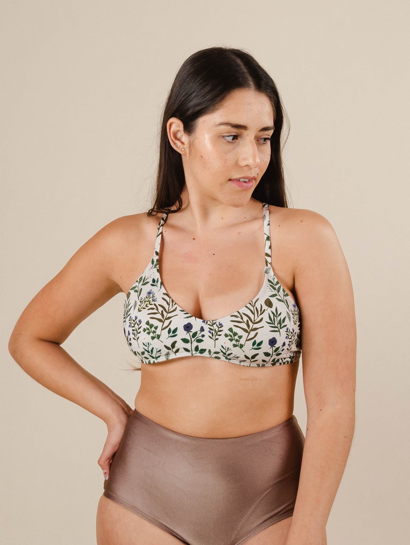 A woman in a Chichi Herboria Bralette Bikini Top and dunes bikini bottom from mimi and august.