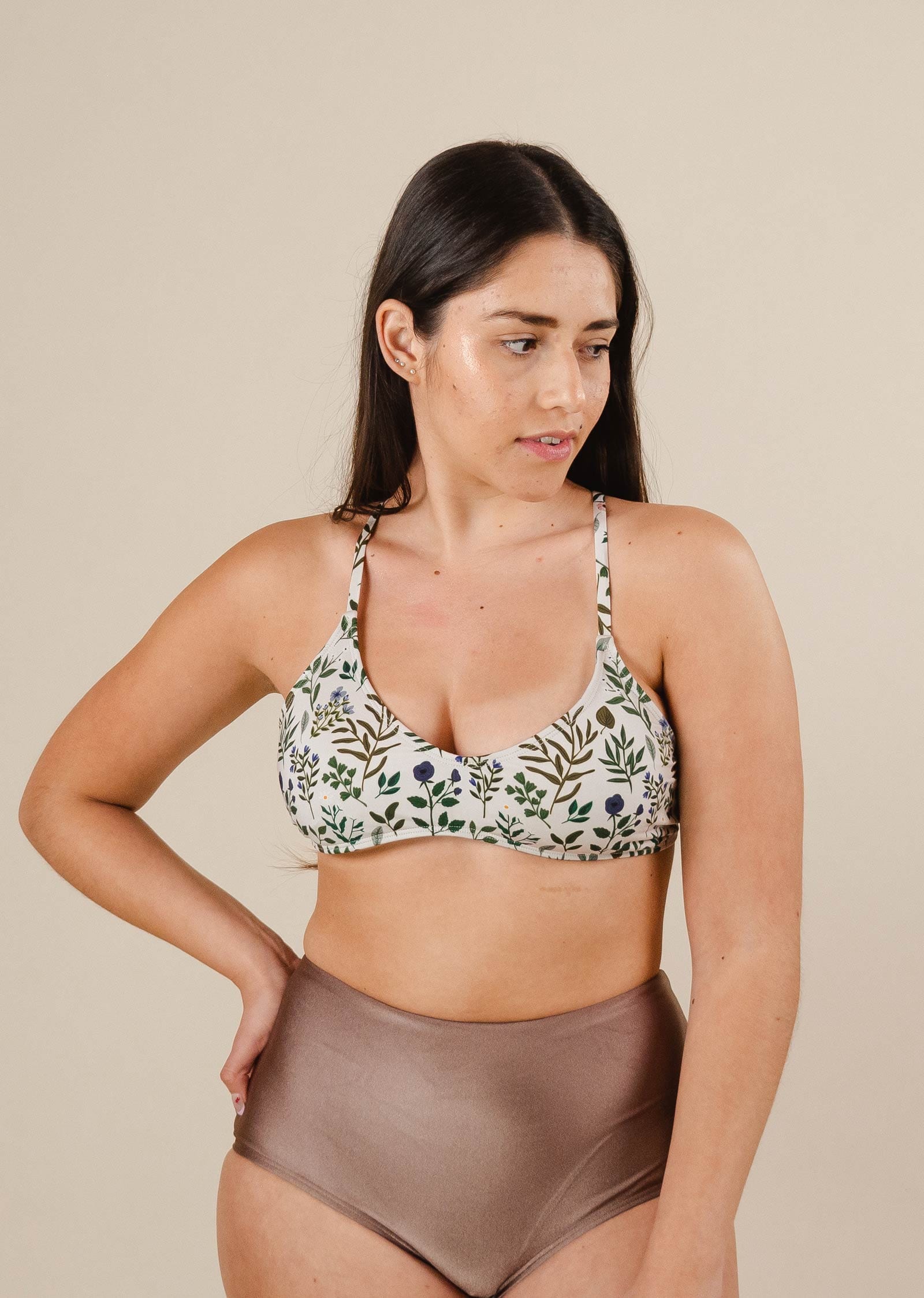 A woman in a Chichi Herboria Bralette Bikini Top and dunes bikini bottom from mimi and august.