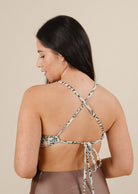 A woman wearing a Chichi Herboria Bralette Bikini Top with a cross back.