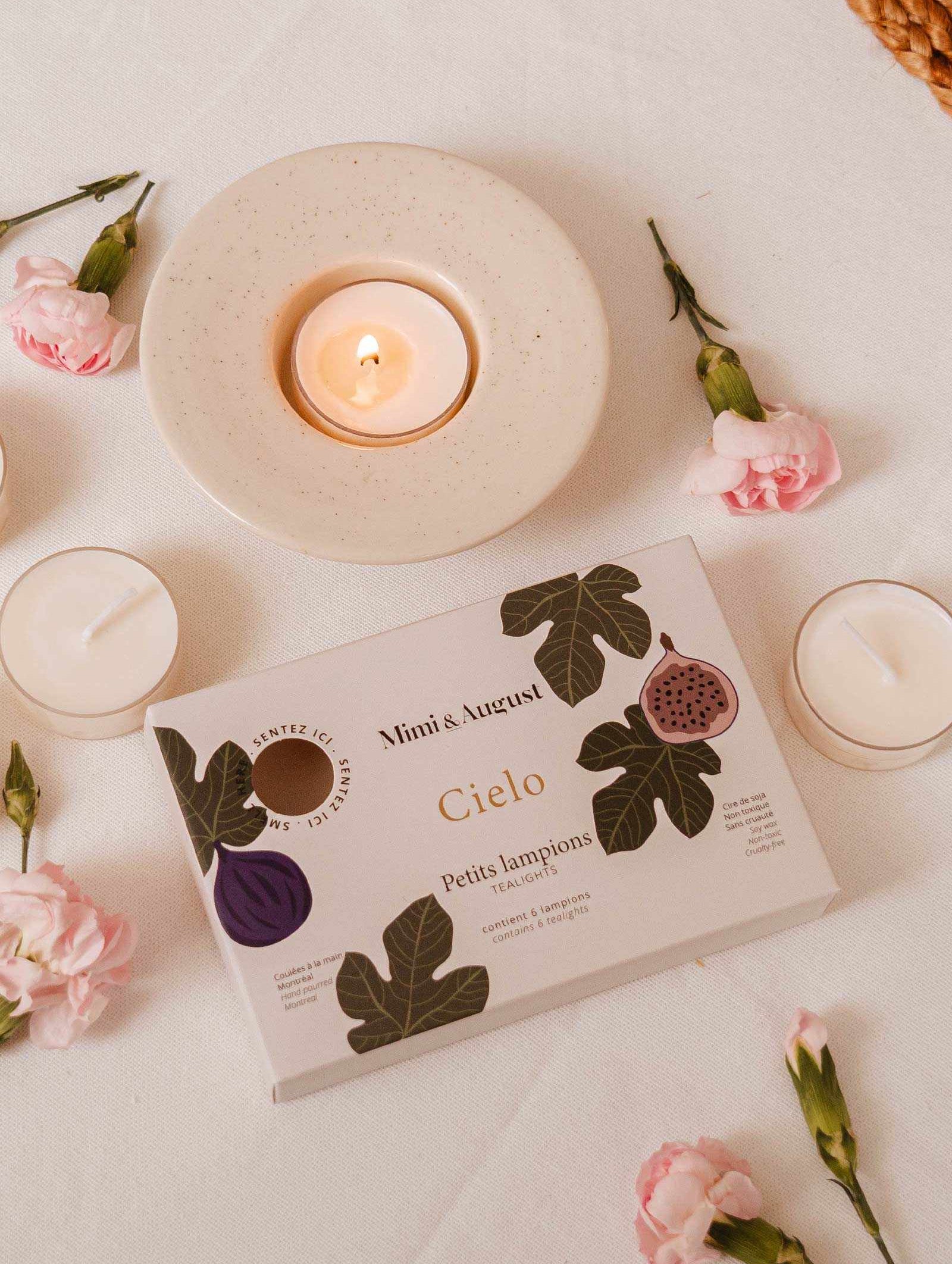 Cielo Tealight Candle Set with six rounded candles emitting warm glowing ambiance and comforting fig, cassis, and amber scent