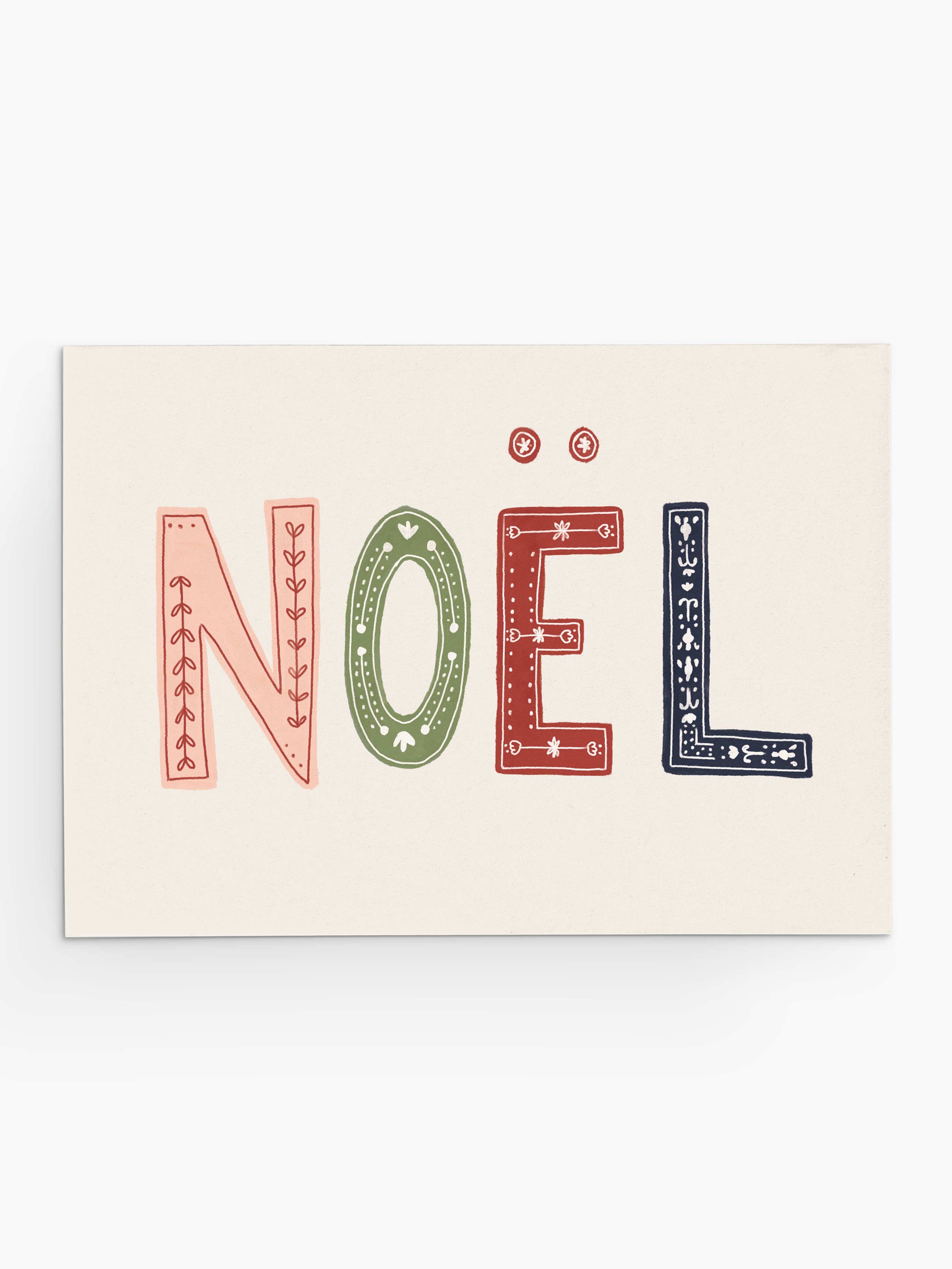 The Enchanted Christmas greeting card from Mimi & August features the text "Noël" in decorative red, green, and blue letters on a plain background, making it ideal for Christmas cards crafted on recycled paper.