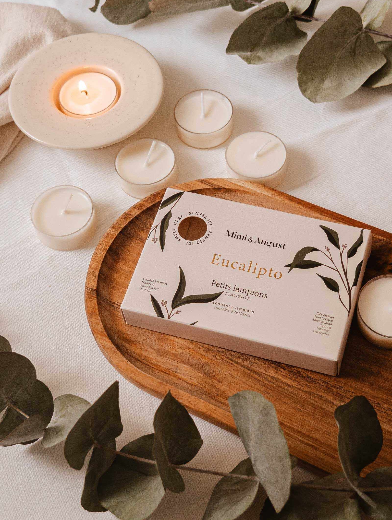 Six round Eucalipto tealight candles emitting fresh eucalyptus scent for calm and clarity.