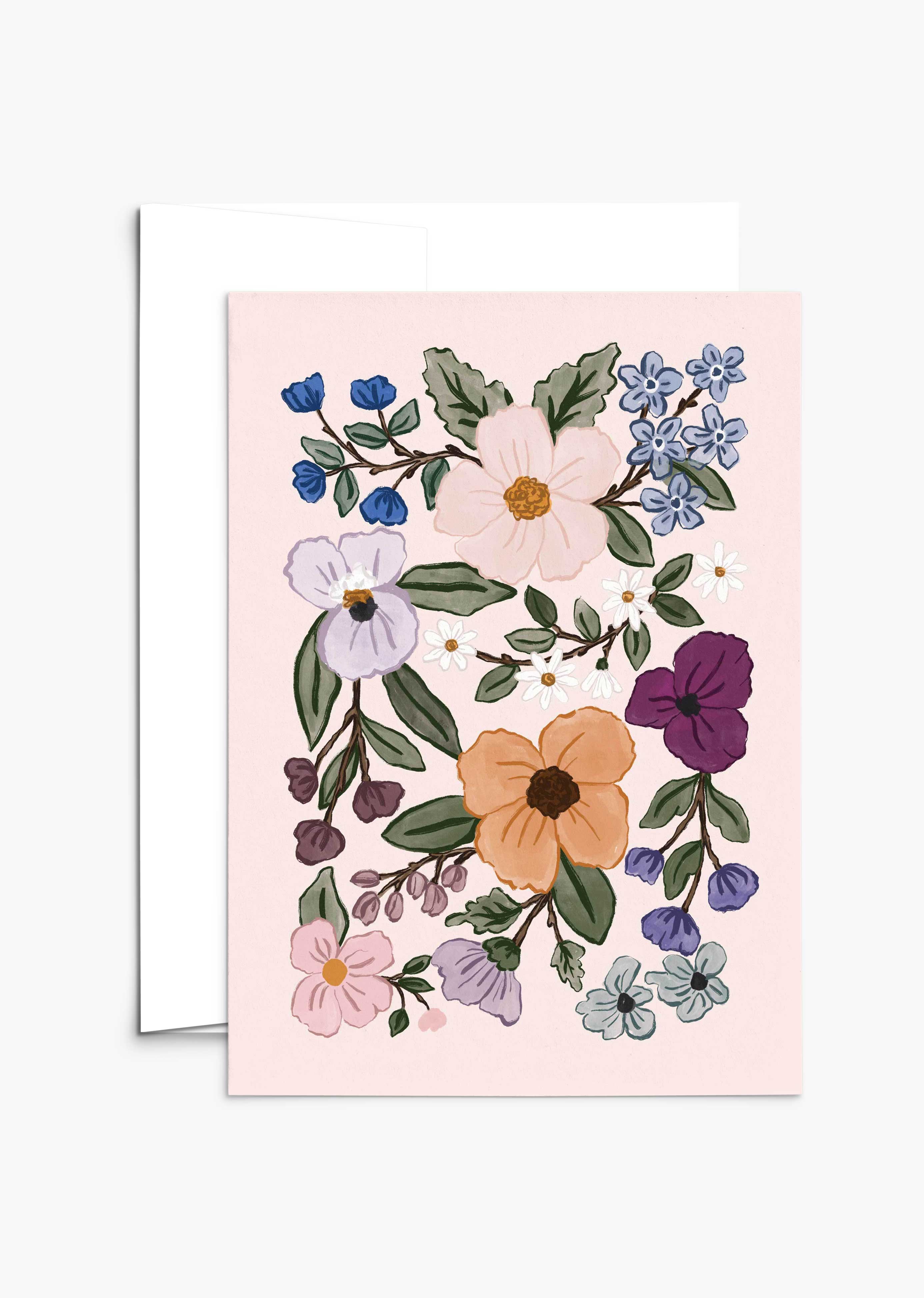 The Mimi & August Field of Flowers Greeting Card features colorful flowers and green leaves on a pink background, paired with an open white envelope for a charming display.