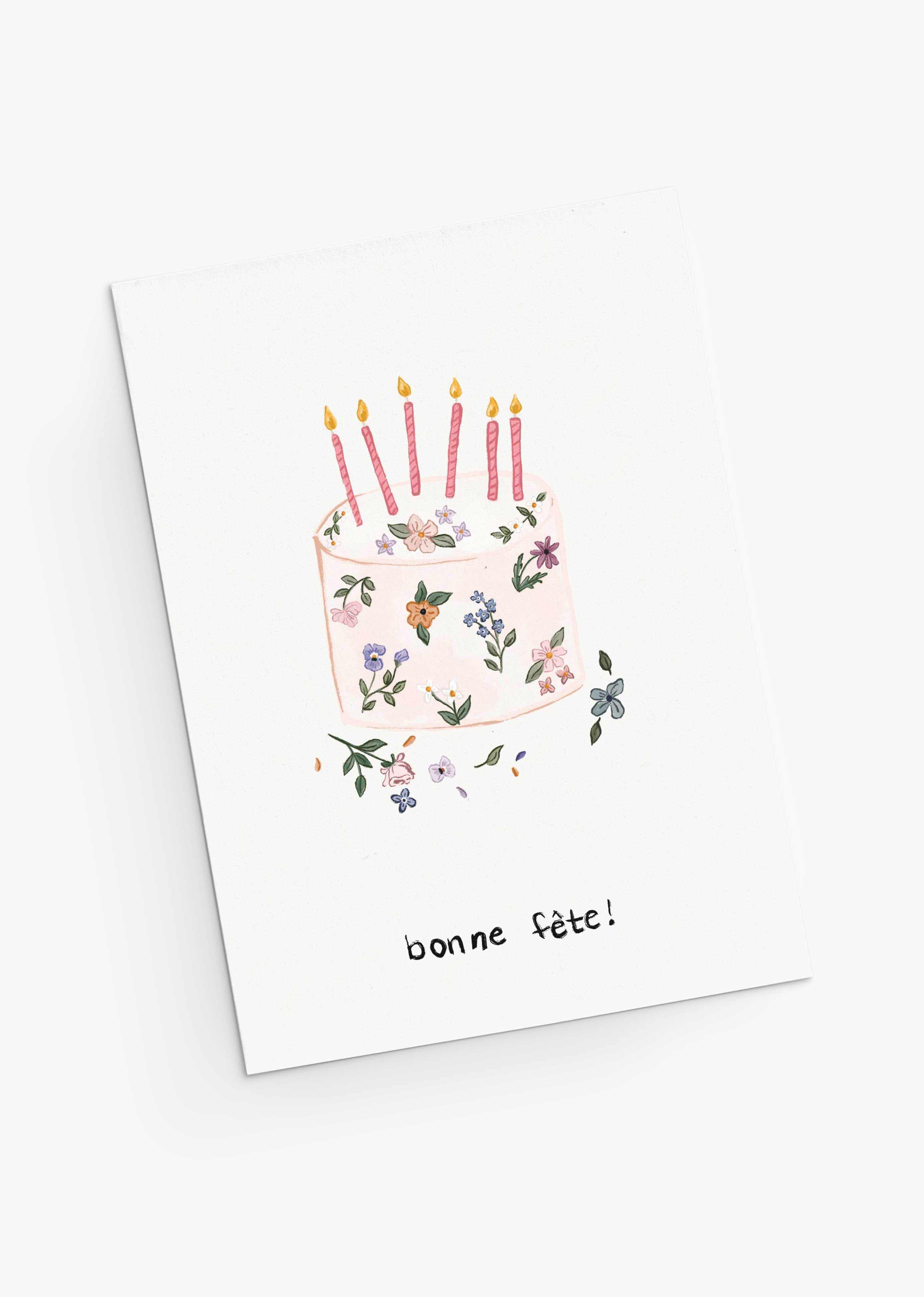 The Mimi & August Floral Birthday Cake Greeting Card features hand-drawn flowers in a cake design with five lit candles and "bonne fête!" below, printed on recycled paper.