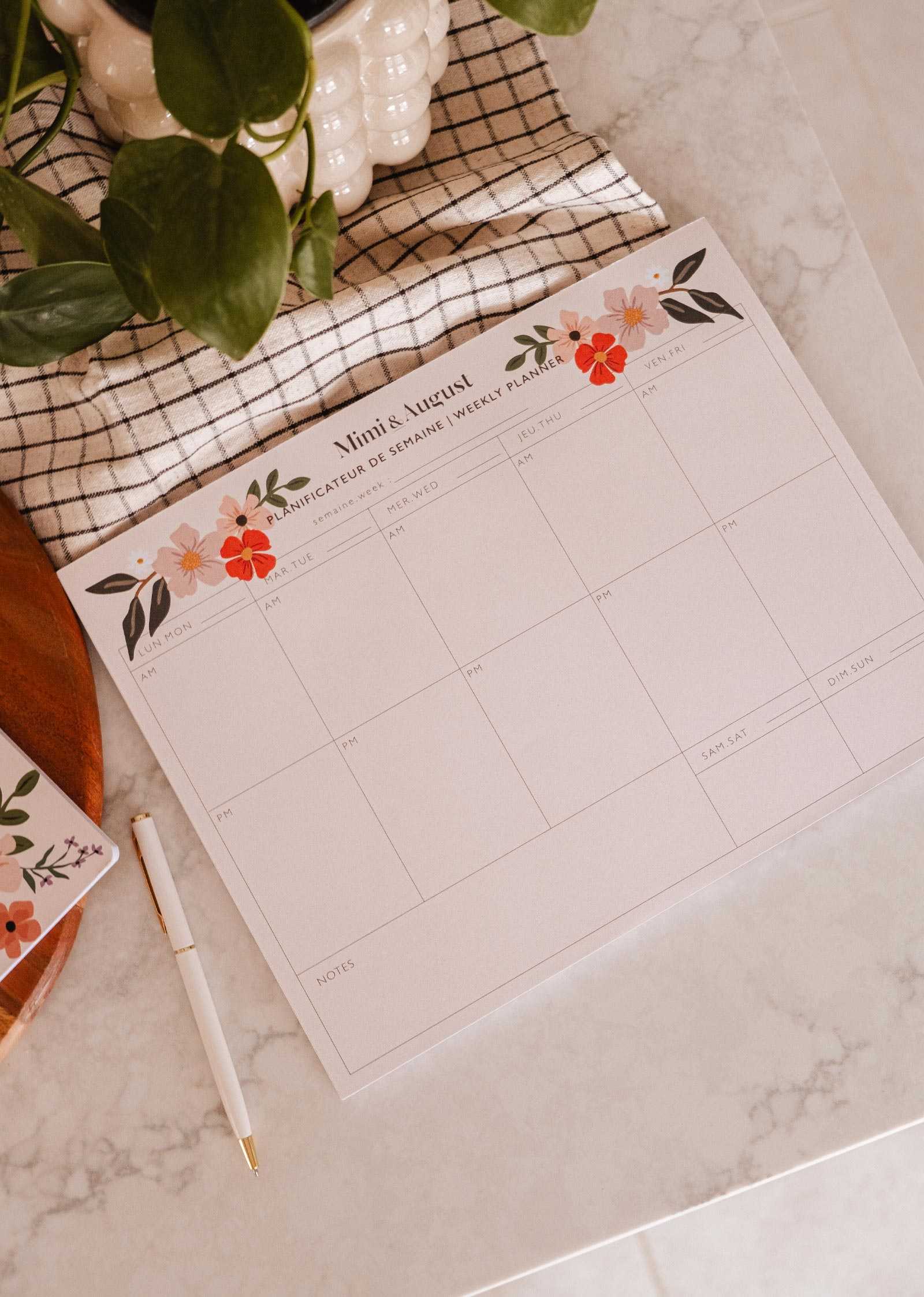 Flower Bomb Weekly Planner open on desk with floral design and eco-friendly features