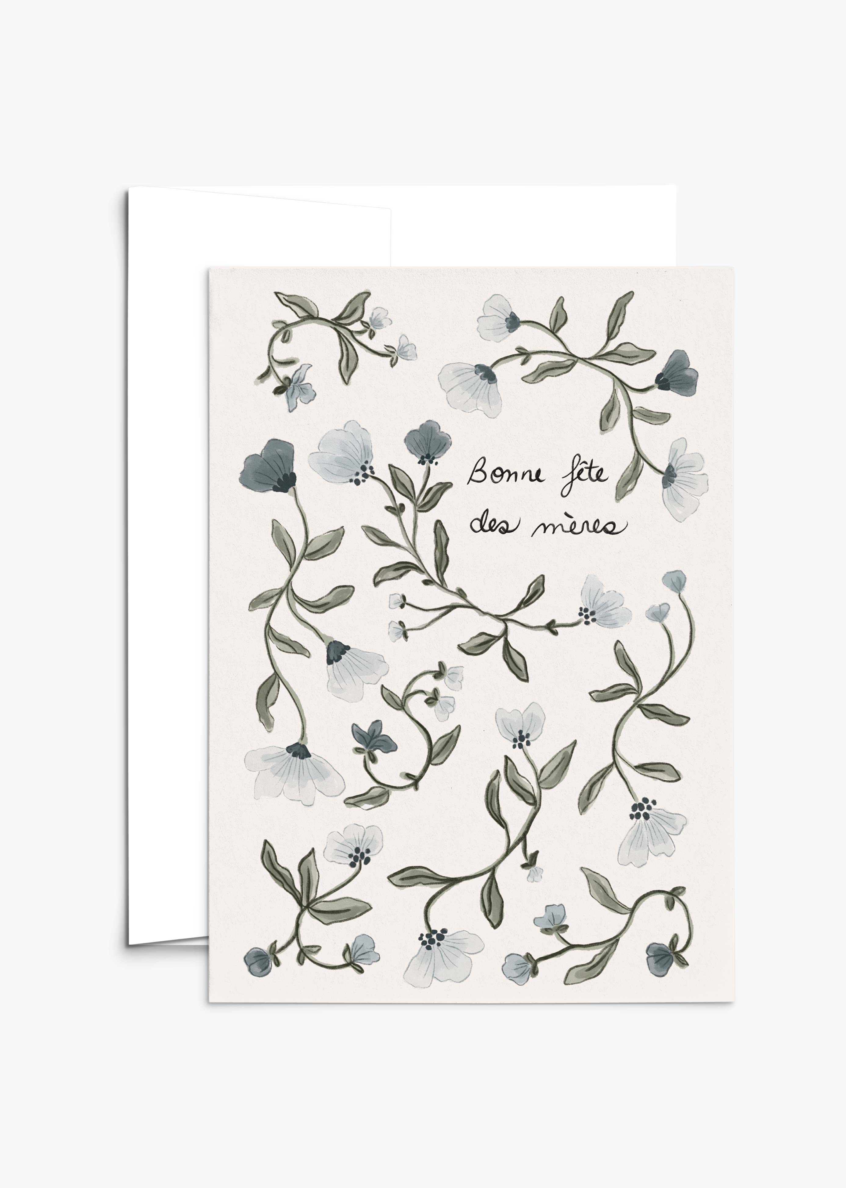 The Blue Flower Mother's Day Greeting Card by Mimi & August features hand-drawn blue florals and "Bonne fête des mères" text with green leaves on a light background, crafted on recycled paper for an eco-friendly touch.