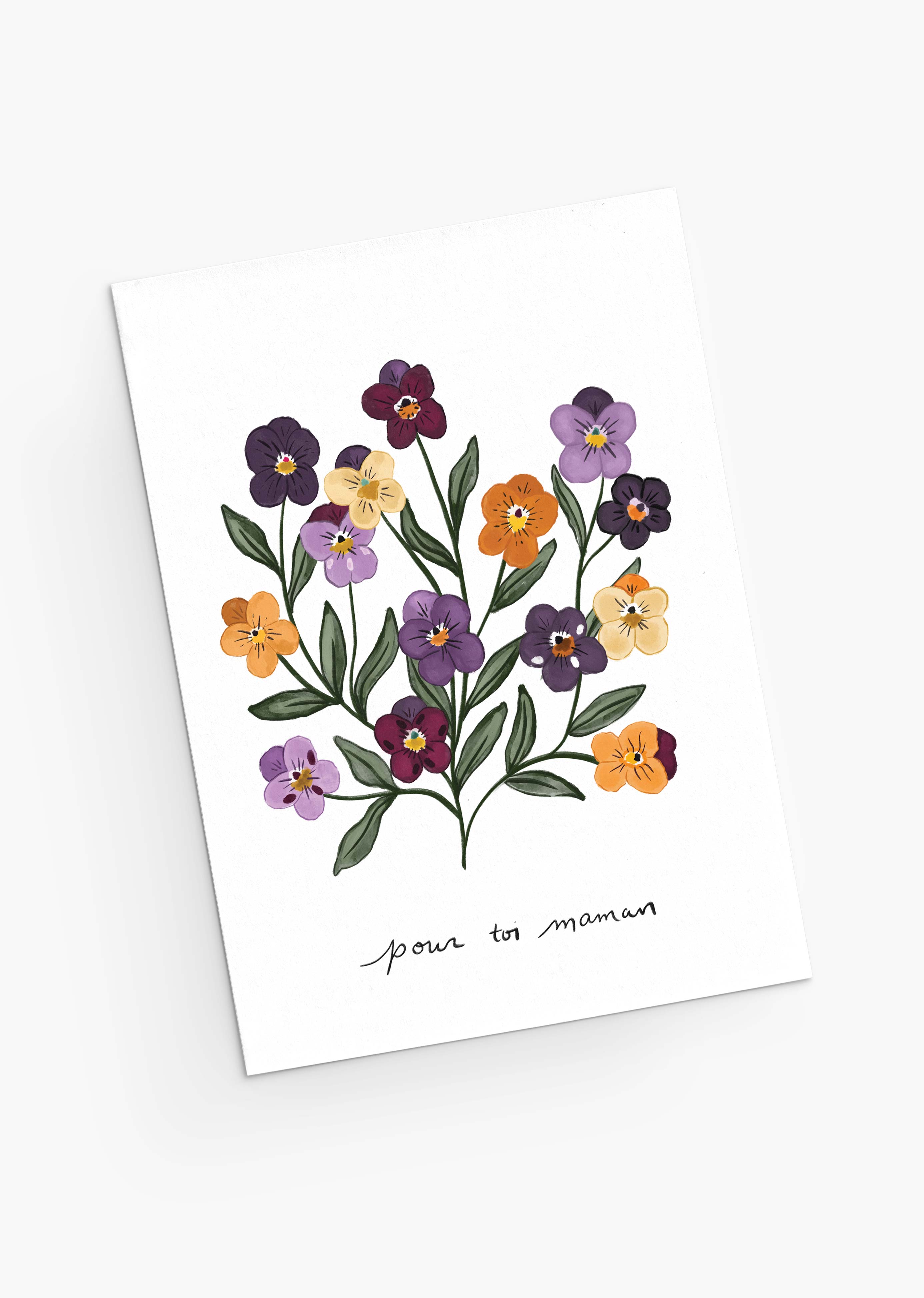 The Violet Mother's Day Greeting Card by Mimi & August showcases colorful illustrated flowers and green leaves with "pour toi maman" at the bottom. It's crafted on recycled paper with compostable packaging, ensuring beauty and eco-friendliness.