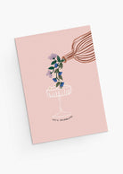 The Let's Celebrate Greeting Card by Mimi & August features a hand-illustrated design of flowers being poured into a glass and "LET'S CELEBRATE!" text on a pink background—a perfect card for any joyful occasion.