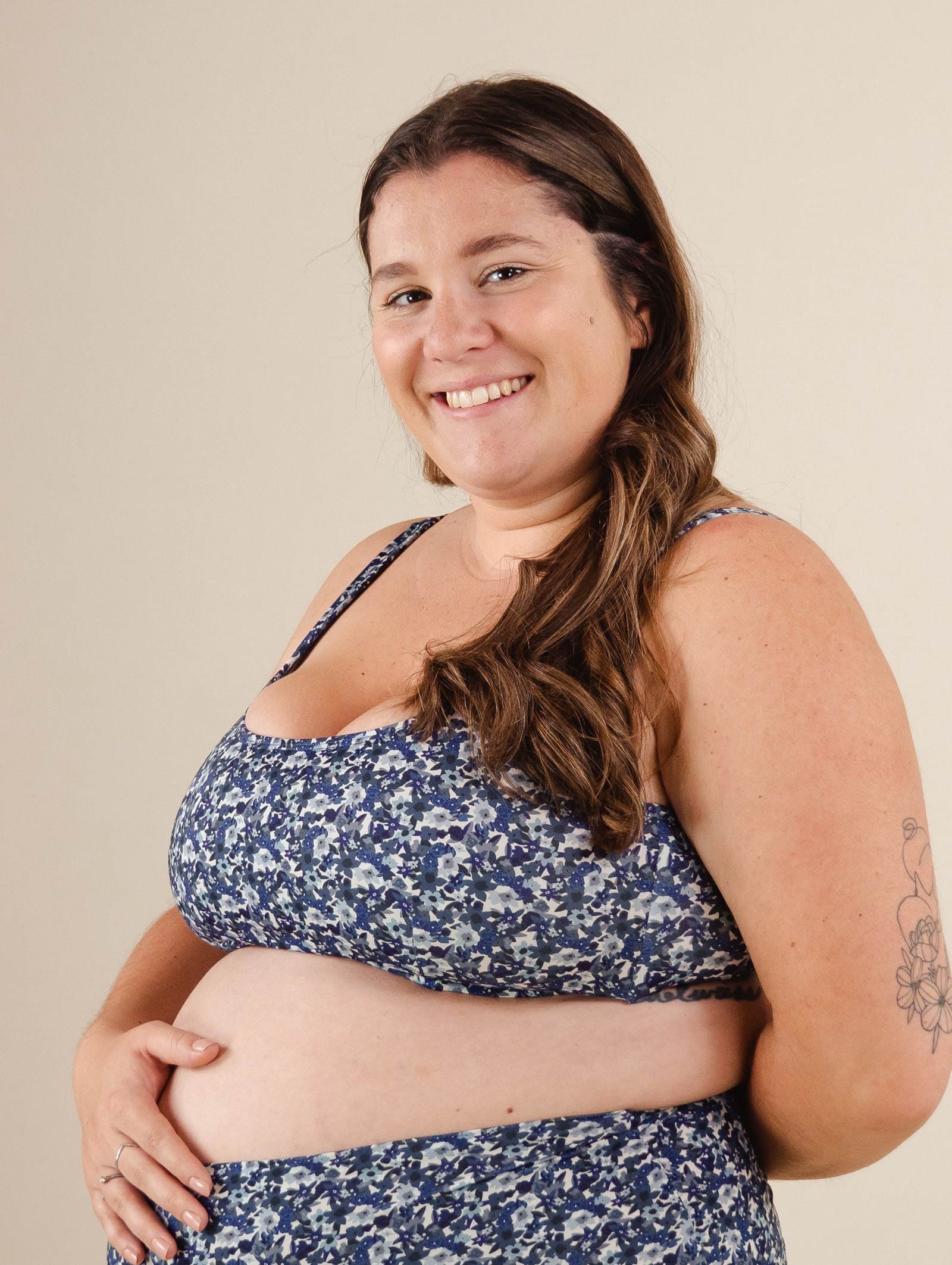 A beautiful pregnant woman in a Lima Moonflower Bralette Bikini Top.