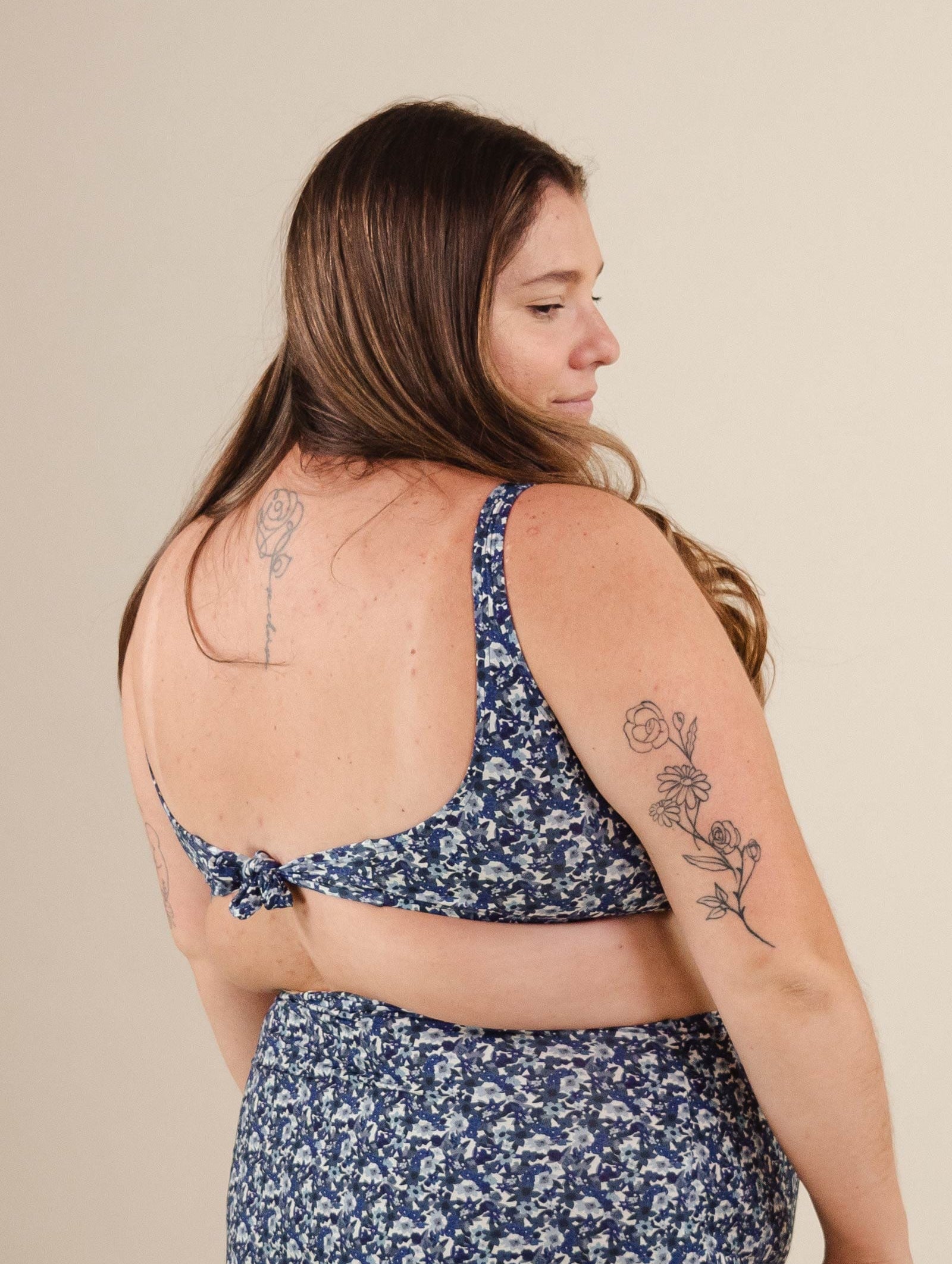 a woman wearing the Lima Moonflower Bralette Bikini Top with a tattoo on her back.