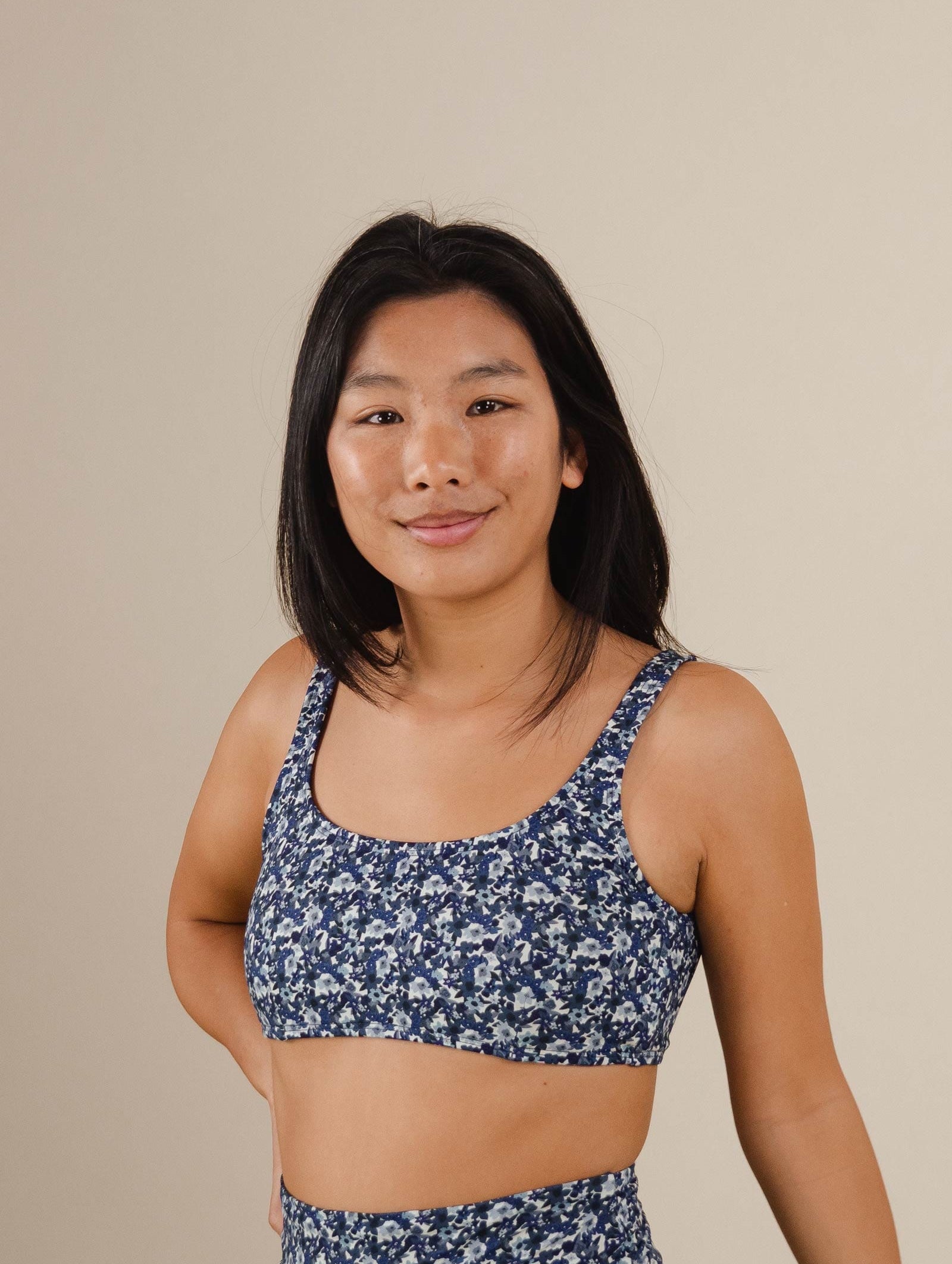 A woman in a mimi and august Lima Moonflower Bralette Bikini Top posing for a picture.