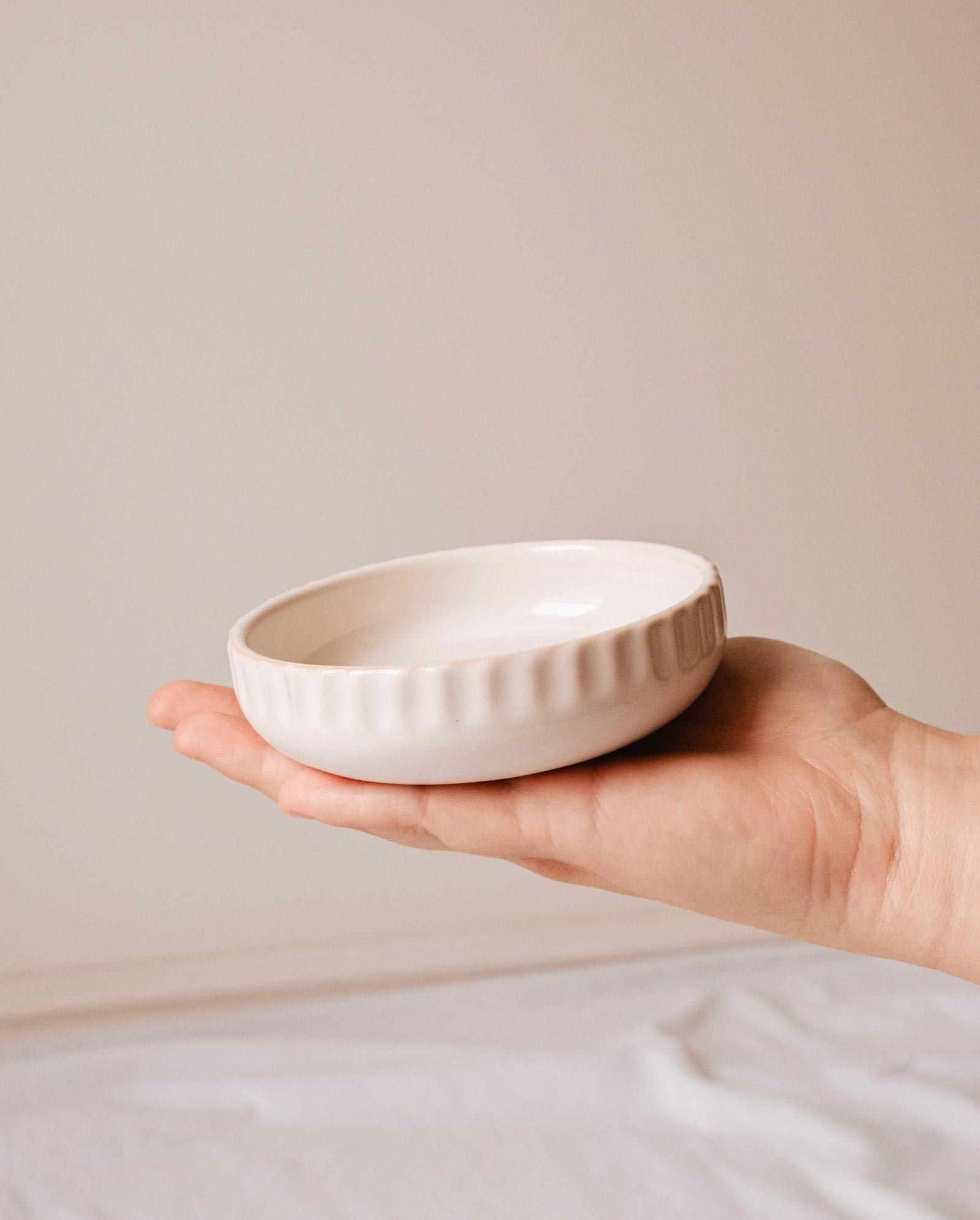 Handcrafted ceramic candle holder Little Ceramic Nest holding a candle refill with minimalist textured design