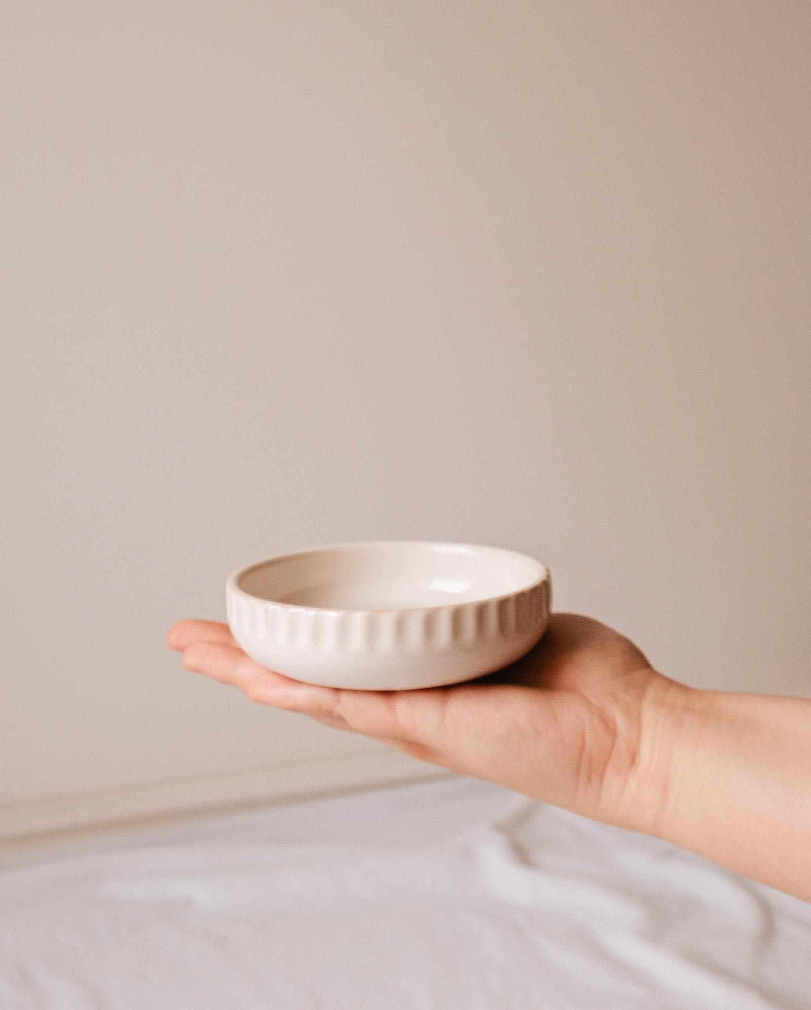 Handcrafted little ceramic candle holder nest with minimalist design and textured surface