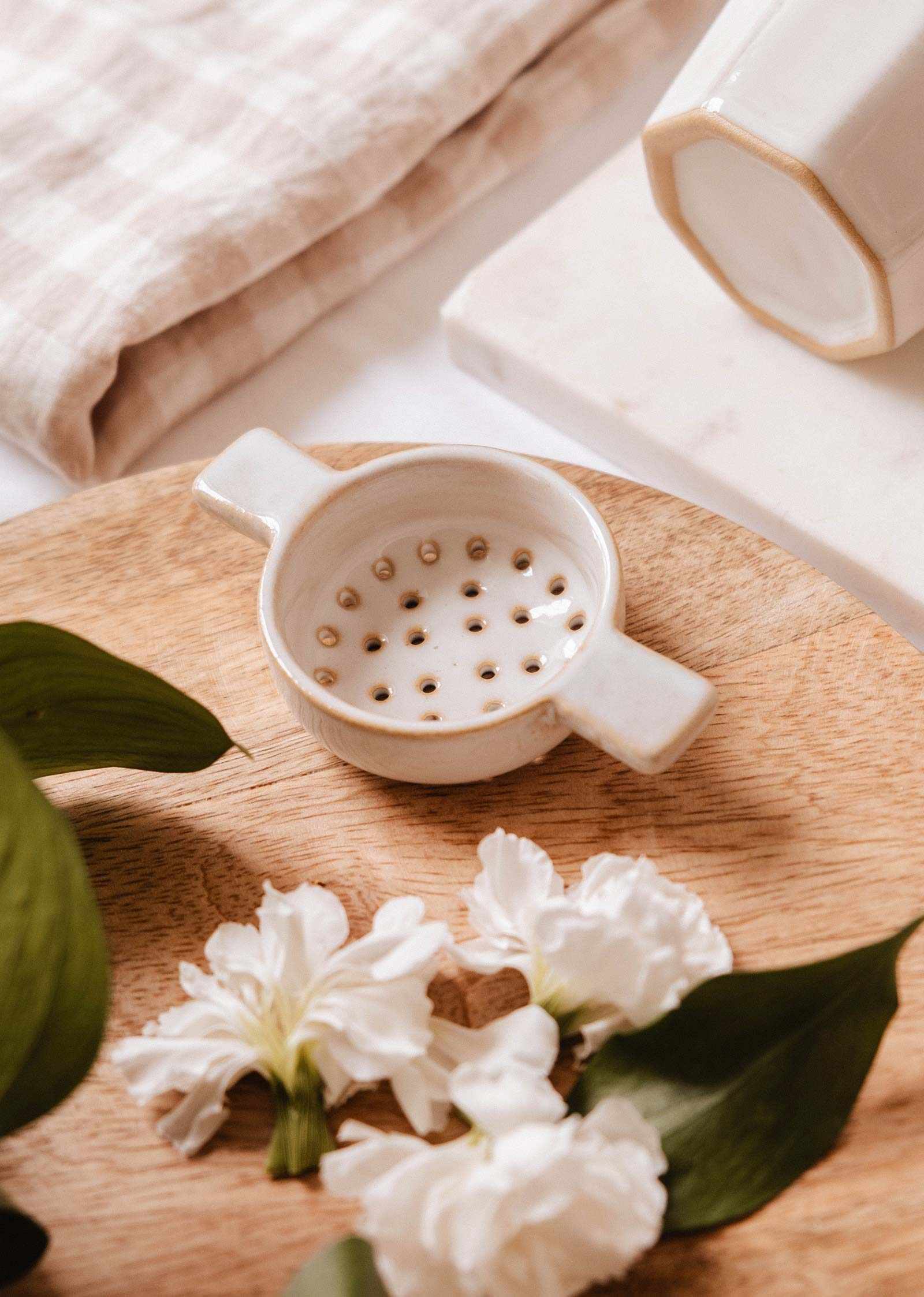 The Infusion Nest ceramic tea strainer in natural handcrafted ceramic fits 8.5 cm mugs for mindful tea brewing