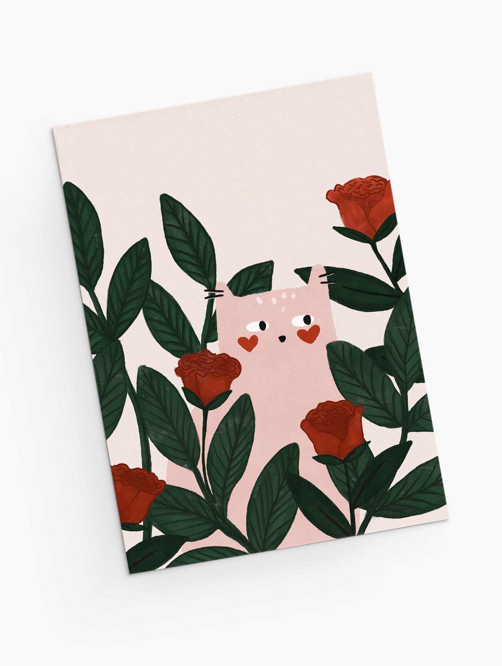 The Lovey Dovey Cat Greeting Card by Mimi & August features a cat with heart-shaped cheeks among green leaves and red roses, ideal for a Valentine's Day greeting on a crisp white background.