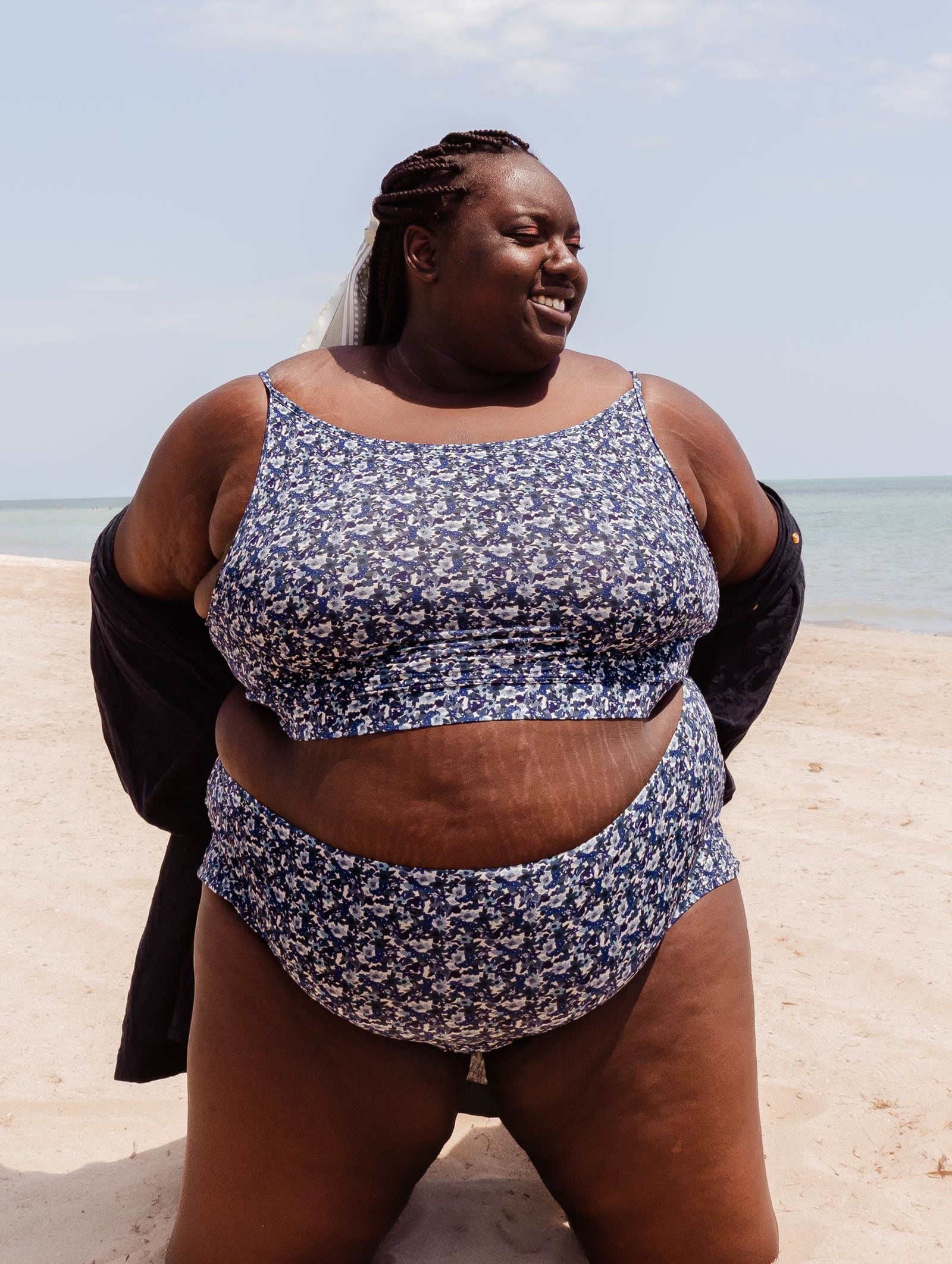 A beautiful woman in a Mango Moonflower Bralette Bikini Top on a beach.