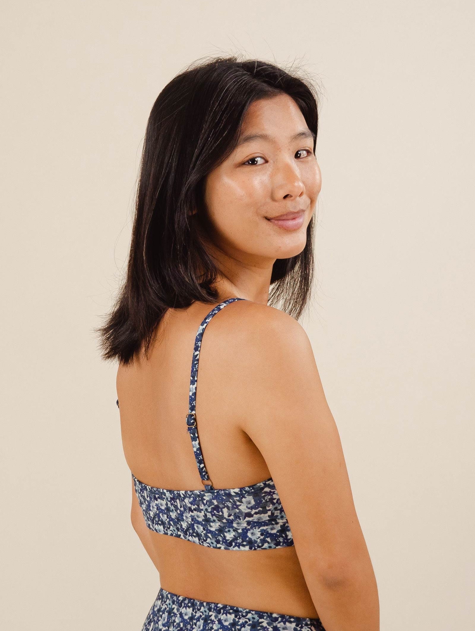 A smiling woman in a Mango Moonflower Bralette Bikini Top.