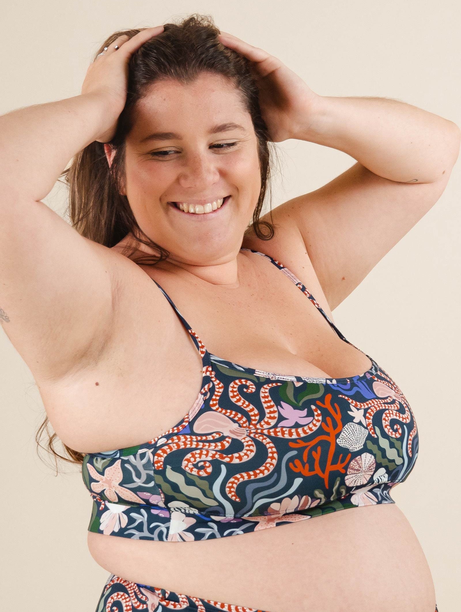 A beautiful woman in a Mango Oceana Bralette Bikini Top posing for a picture.