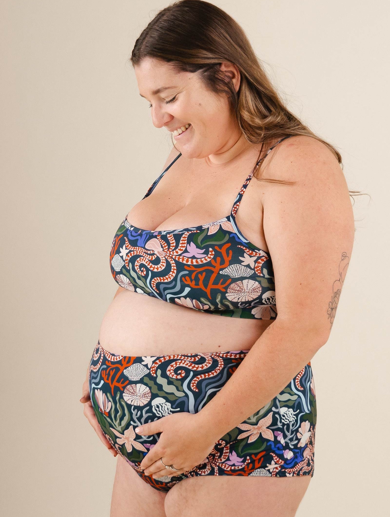 A pregnant woman in a Mango Oceana Bralette Bikini Top.