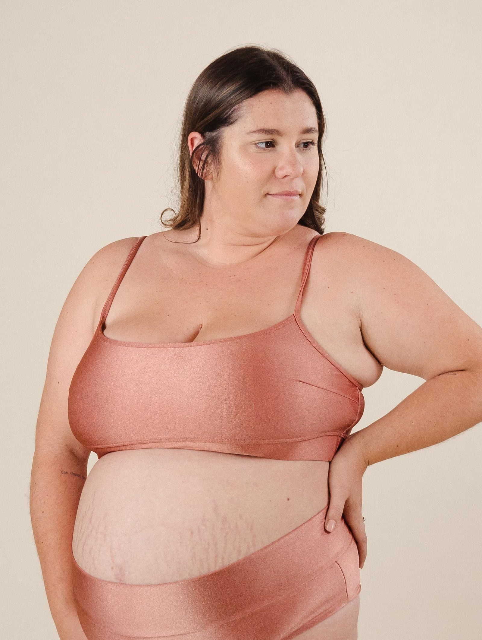 A pregnant woman in a Mango Sunset Bralette Bikini Top with excellent support.