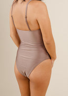 A sexy woman in the Nohea Dunes one-piece swimsuit.