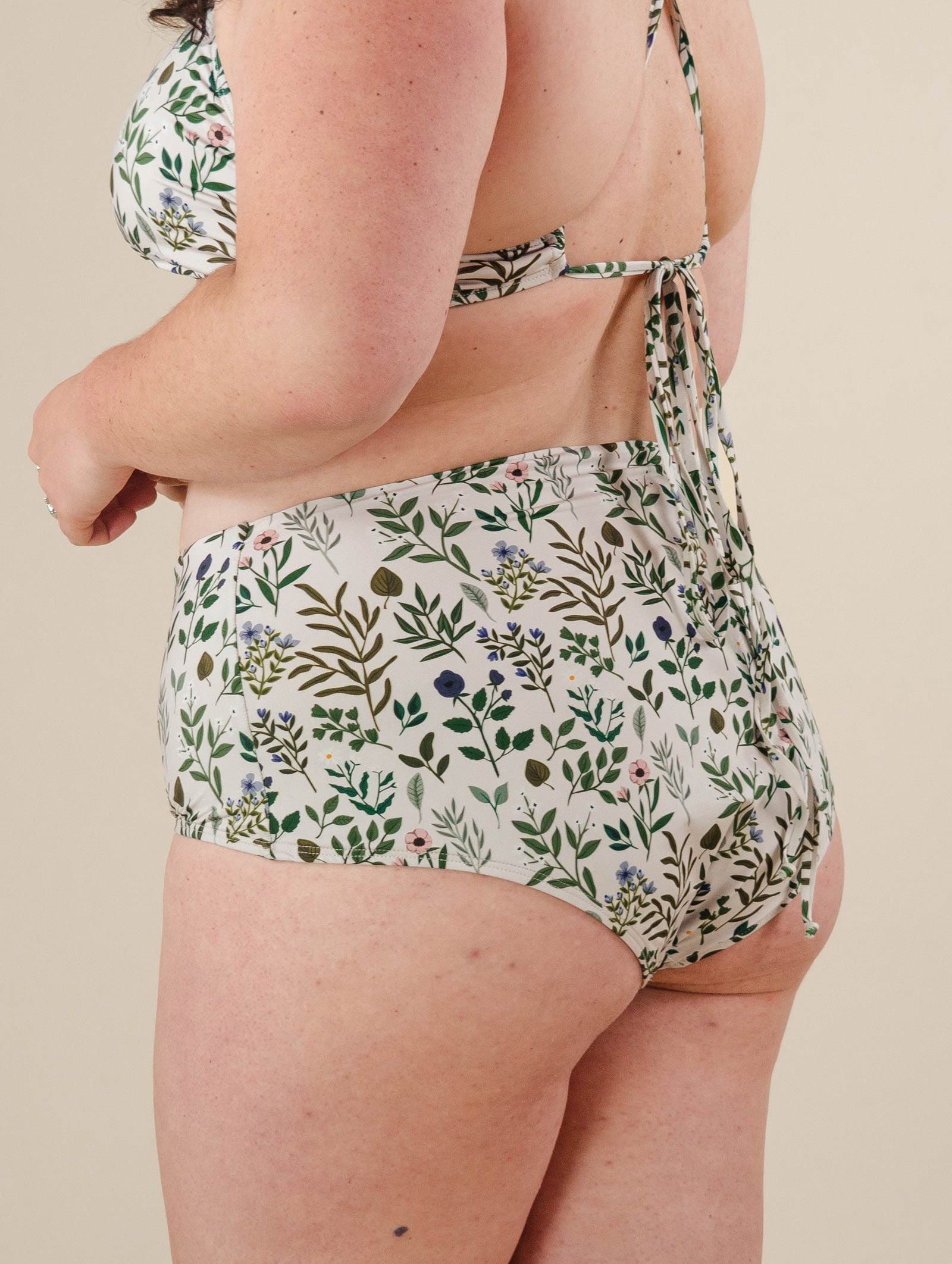 A woman wearing the mimi and august High Waist floral Bikini Bottom.