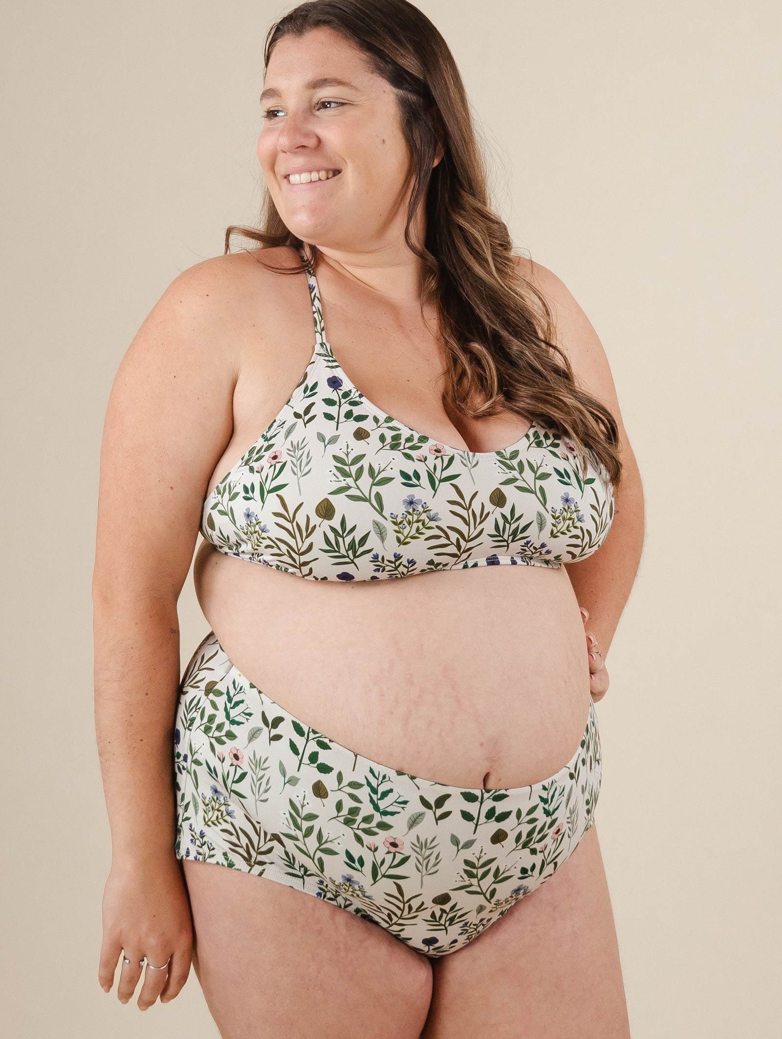 A pregnant woman in a mimi and august High Waist floral Bikini Bottom.