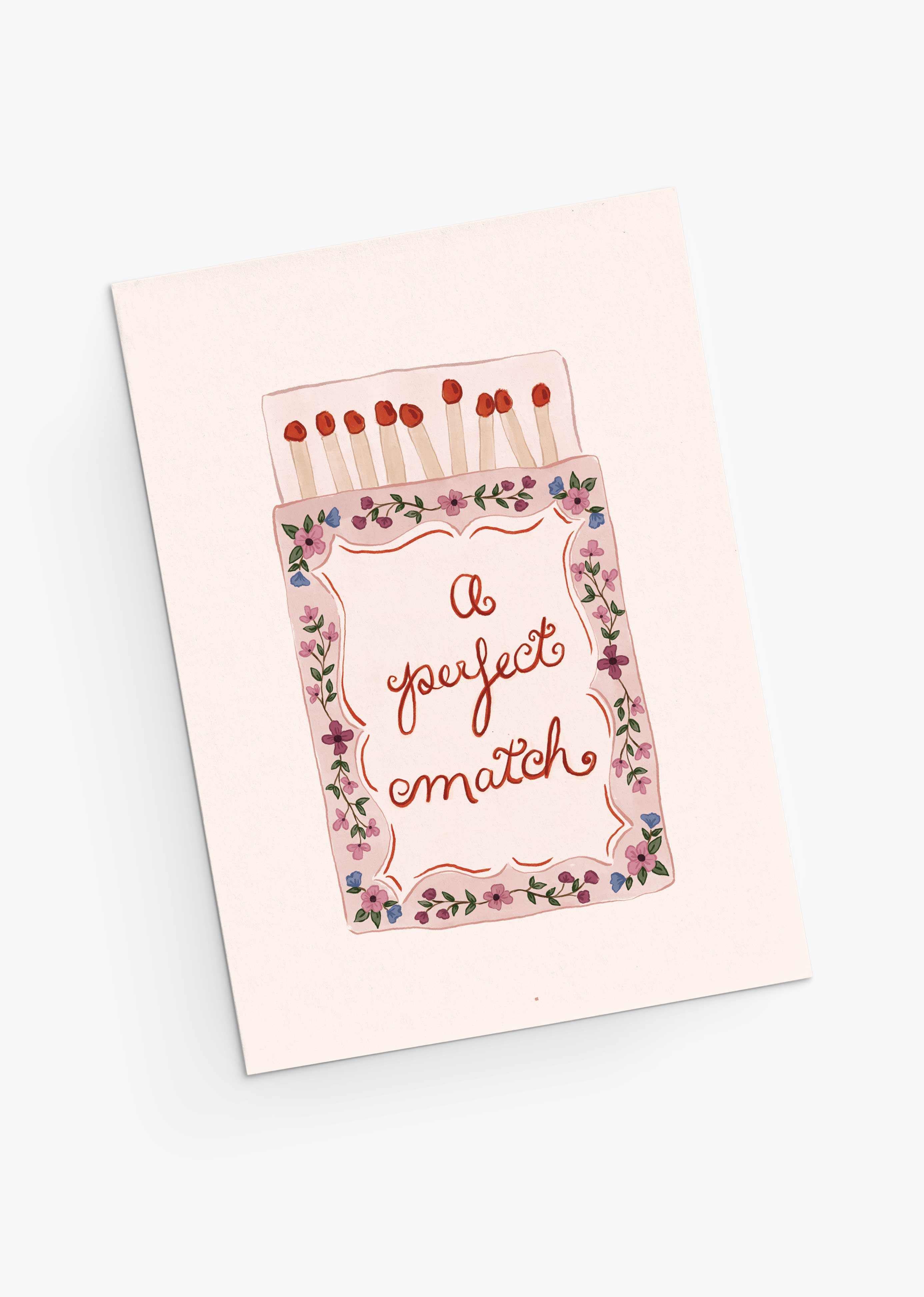 The Perfect Match Greeting Card by Mimi & August features a matchbox and floral border with "A perfect match." Printed on recycled paper, it’s an eco-friendly way to share heartfelt Valentine's Day wishes.