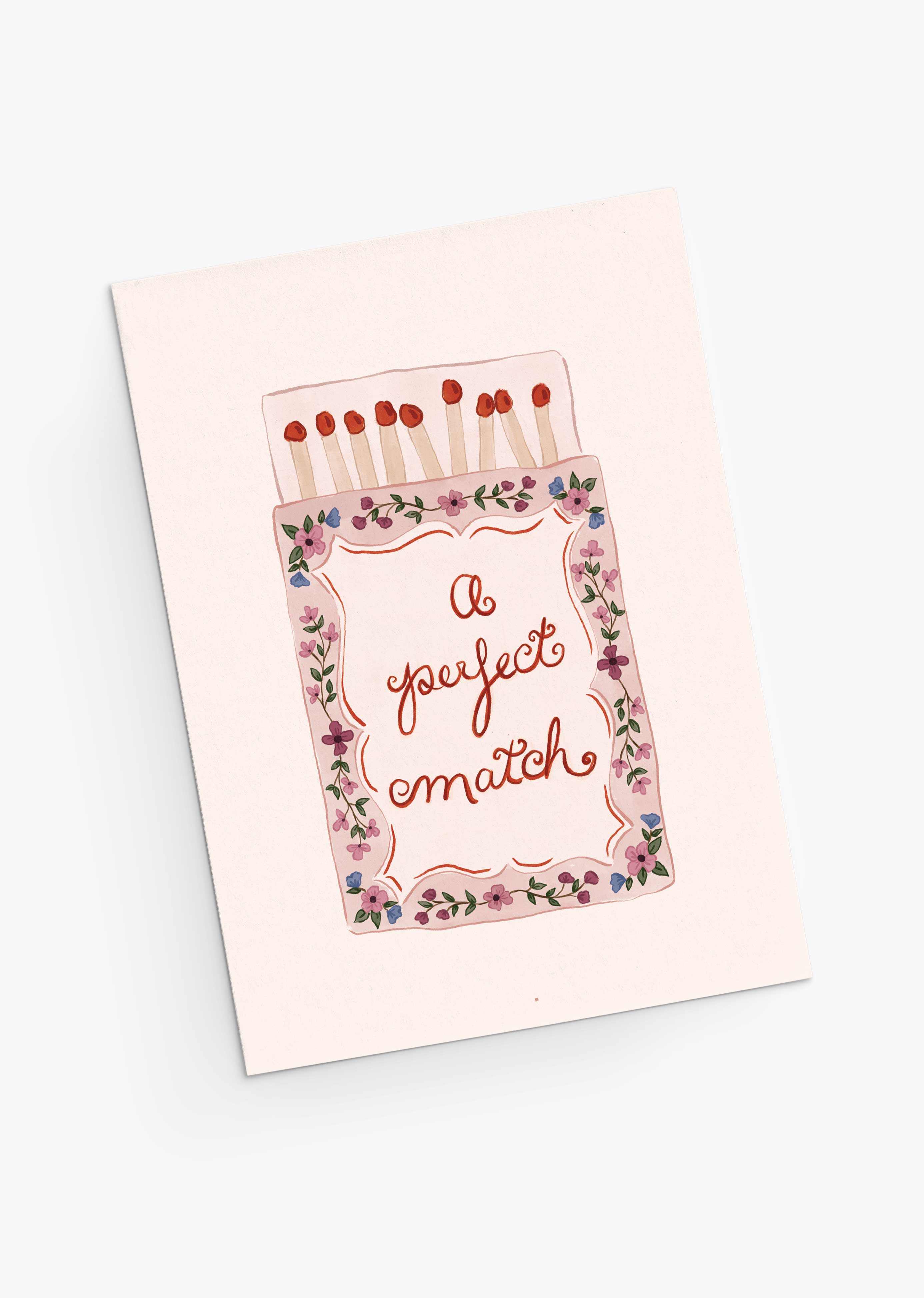 The Perfect Match Greeting Card by Mimi & August features a matchbox and floral border with "A perfect match." Printed on recycled paper, it’s an eco-friendly way to share heartfelt Valentine's Day wishes.