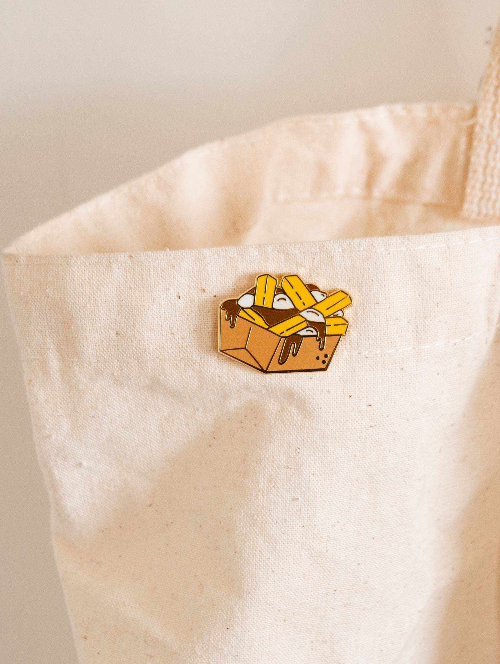 A Poutine in a white tote bag by mimi and august.
