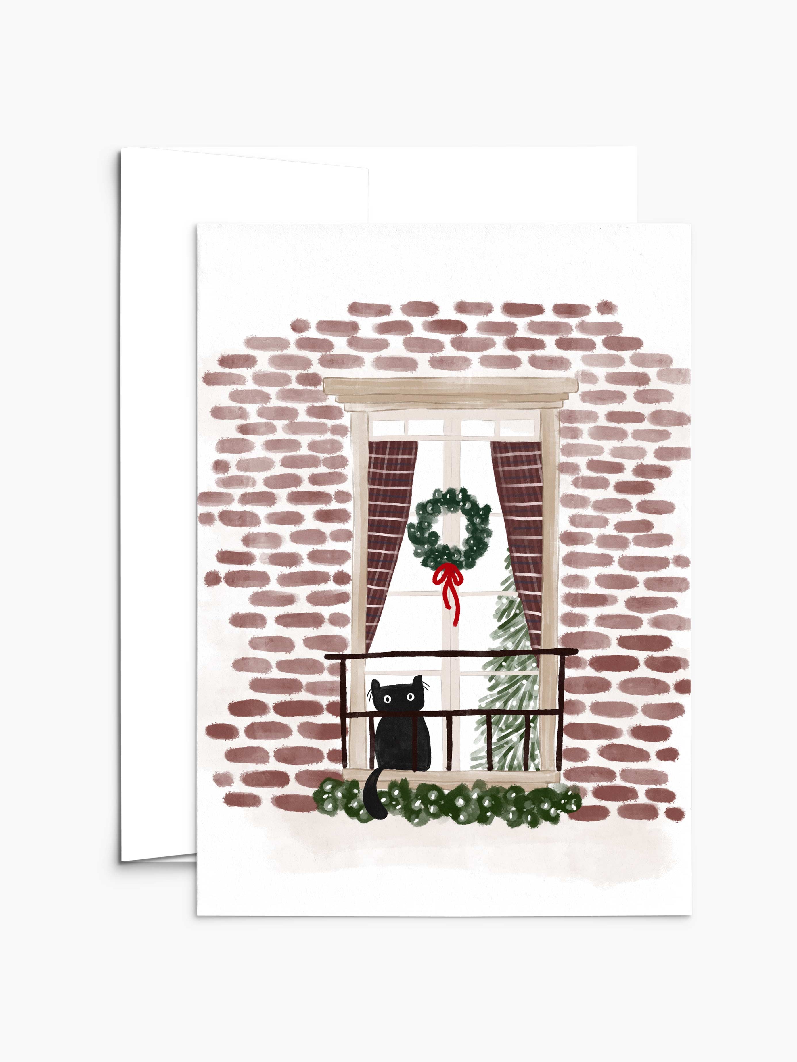 The "Purr-fectly Waiting for Santa - Christmas Greeting Card" by Mimi & August beautifully depicts a black cat on a balcony with a brick wall backdrop, a Christmas wreath on the window, and an indoor festive tree—the perfect scene for holiday cards printed on recycled paper.