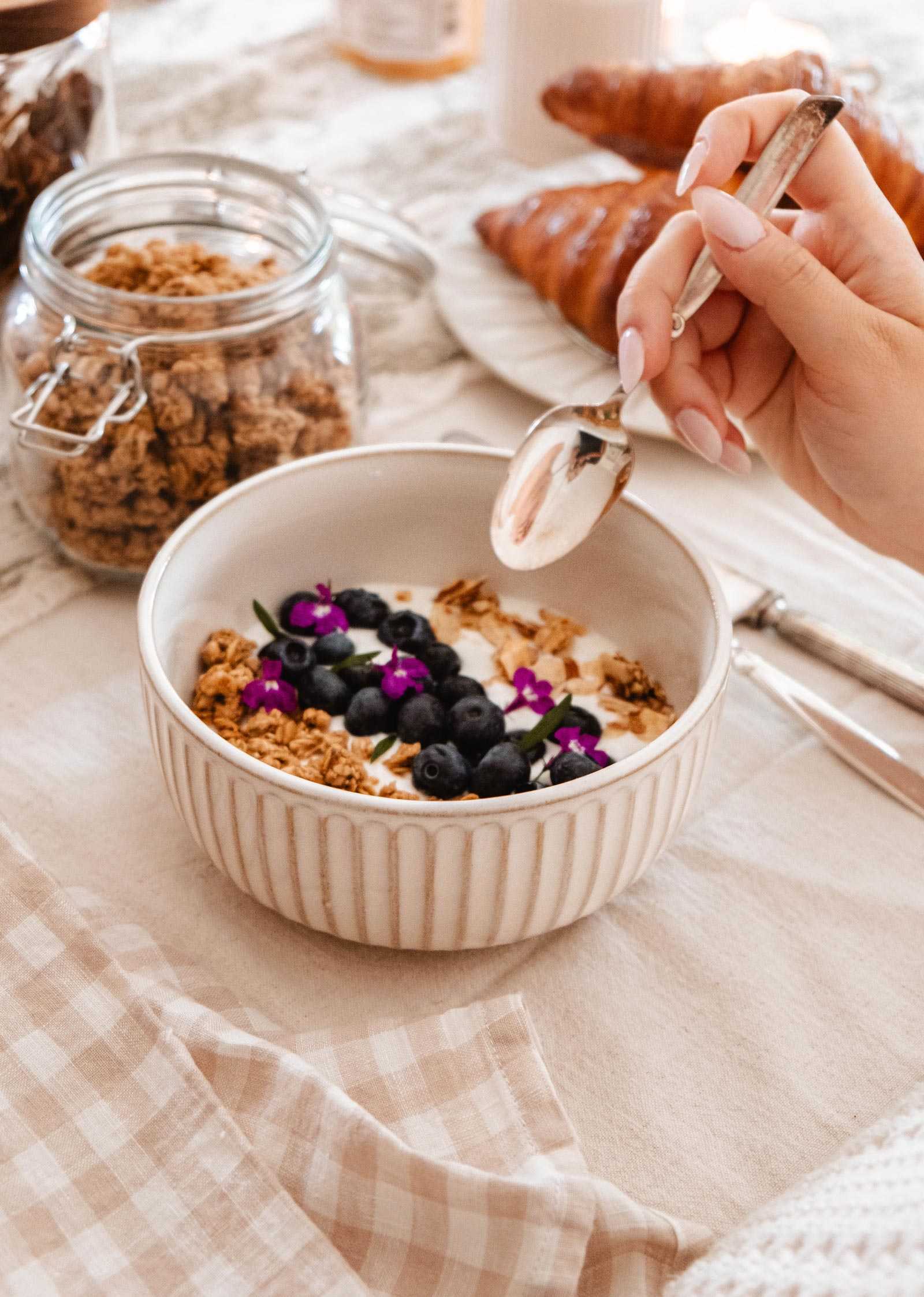 Ceramic bowl by Mimi & August on saucer, styled with candles and granola jars