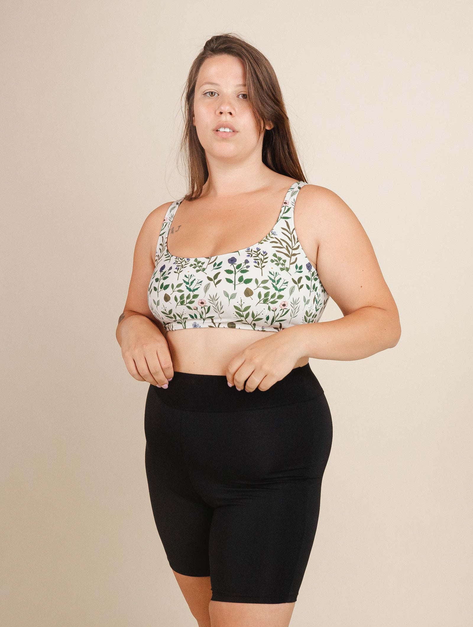 a woman in mimi and august bikini lima floral top and black swim biker short.