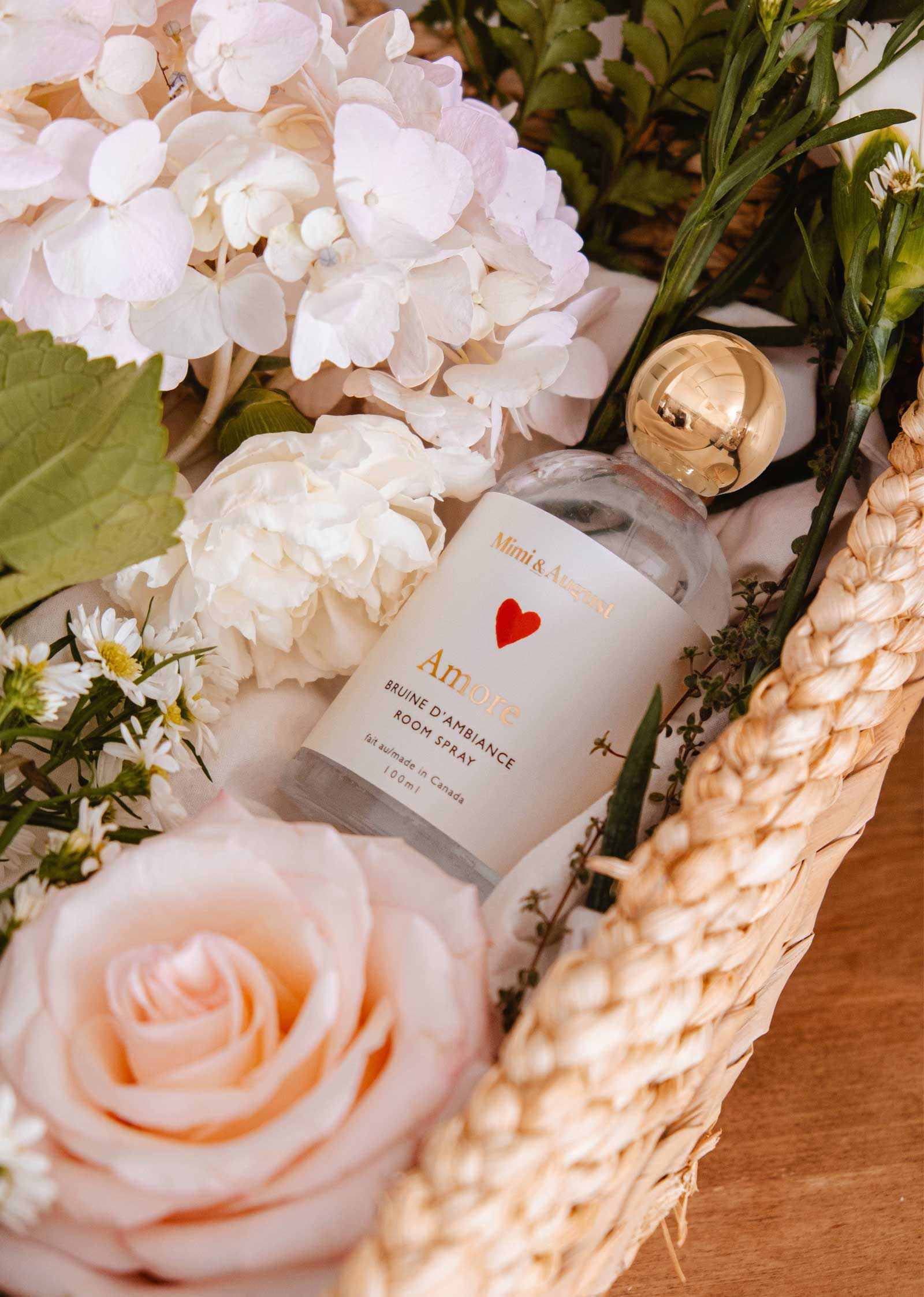 Amore Room Spray bottle with white tea, grapefruit, and rose petal scent for a romantic atmosphere