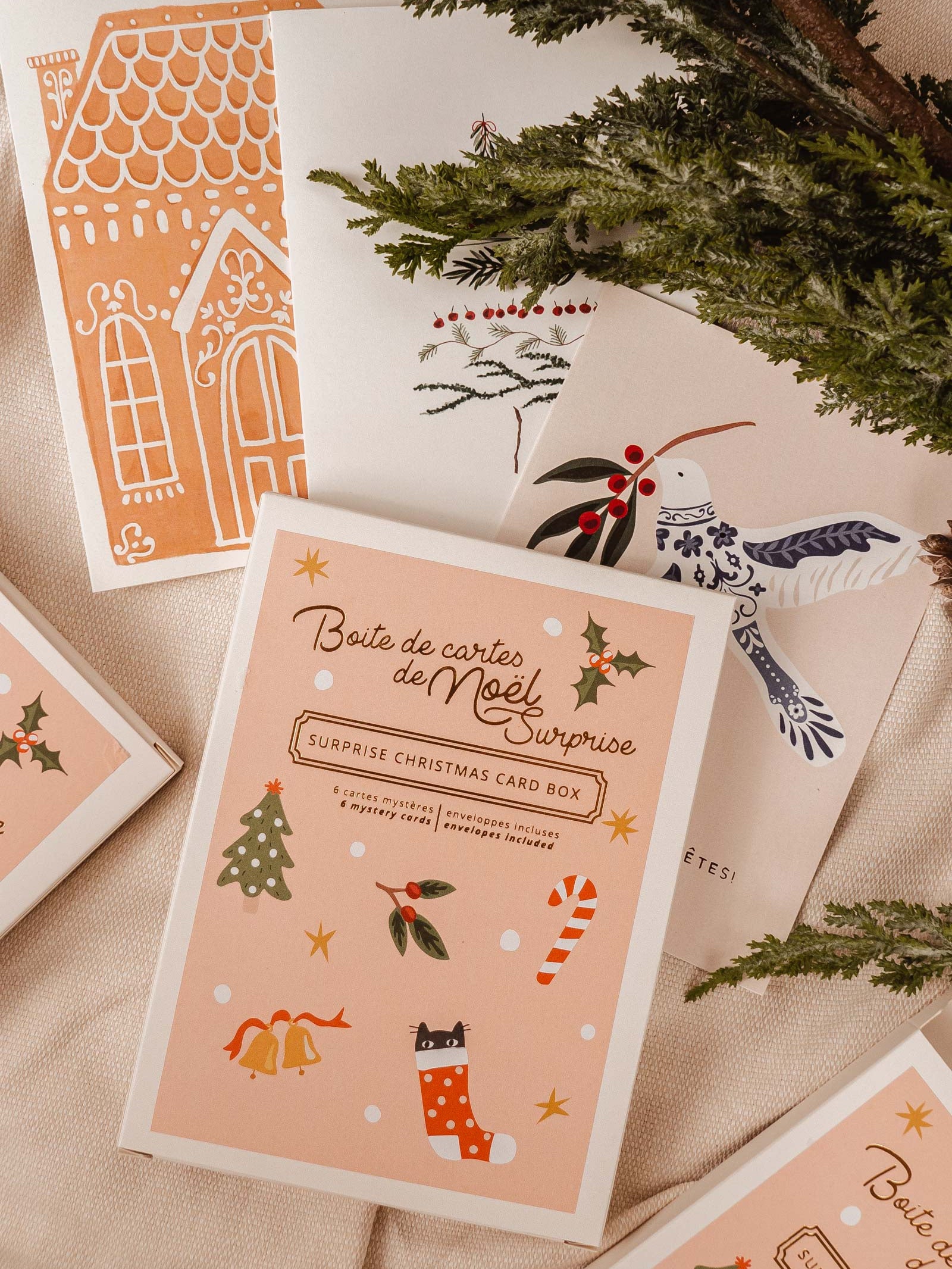 Surprise! cute box with a sticker on top containing 6 beautiful Christmas greeting card. By Mimi & August