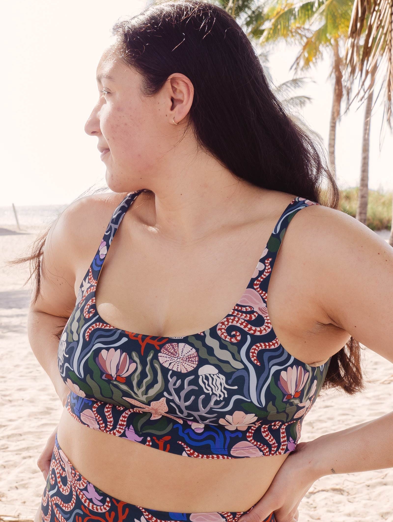 A woman elegantly posing in a Mimi and August Bikini ocean pattern print