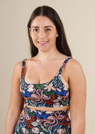 A woman in a aquatic print Tahiti Oceana bikini top, by Mimi and August, posing for a photo.