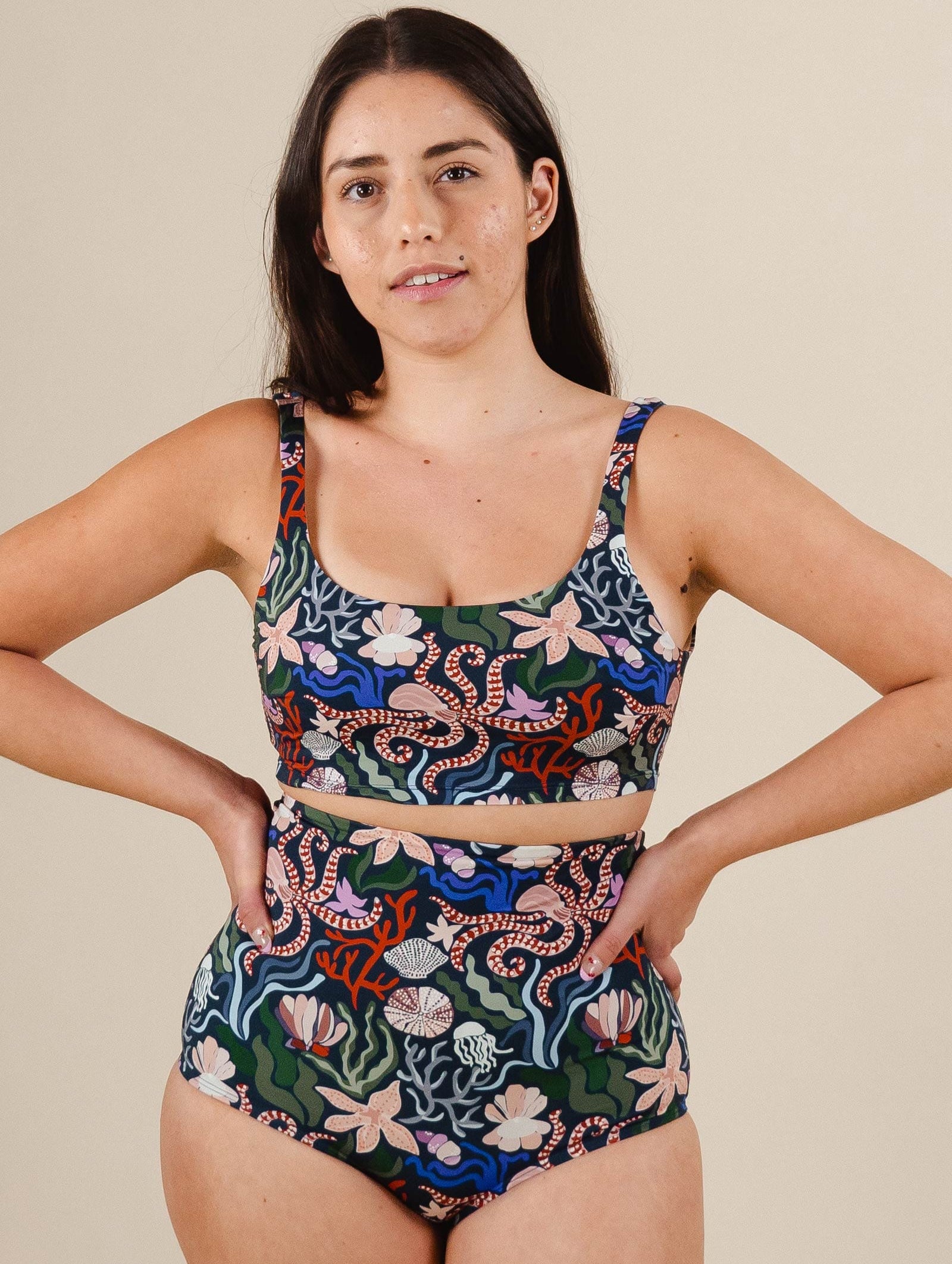 A latin woman in a Tahiti Oceana Bralette Bikini Top by mimi and august