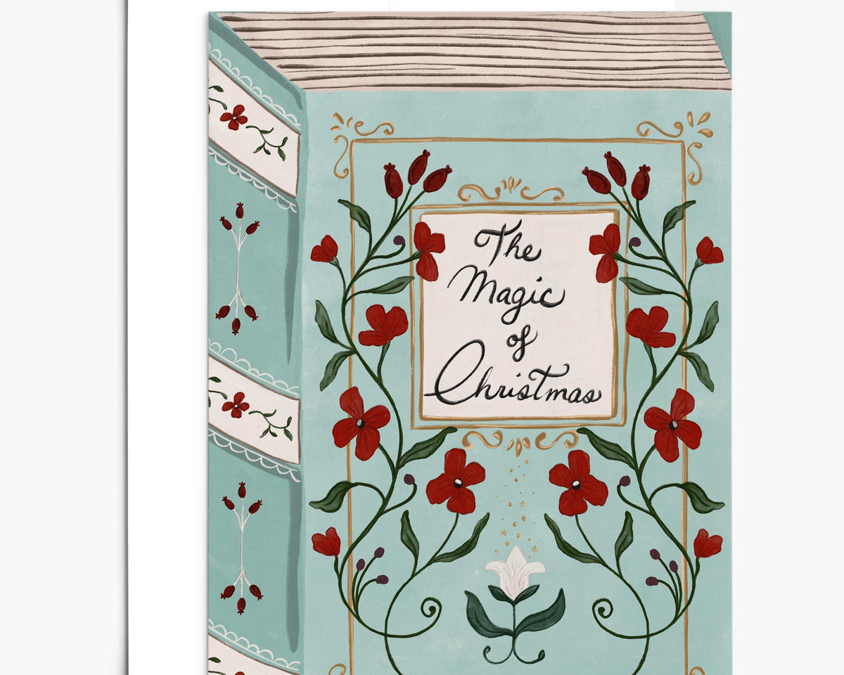 The Magic of Christmas vintage storybook style greeting card with soft blue background and red floral details