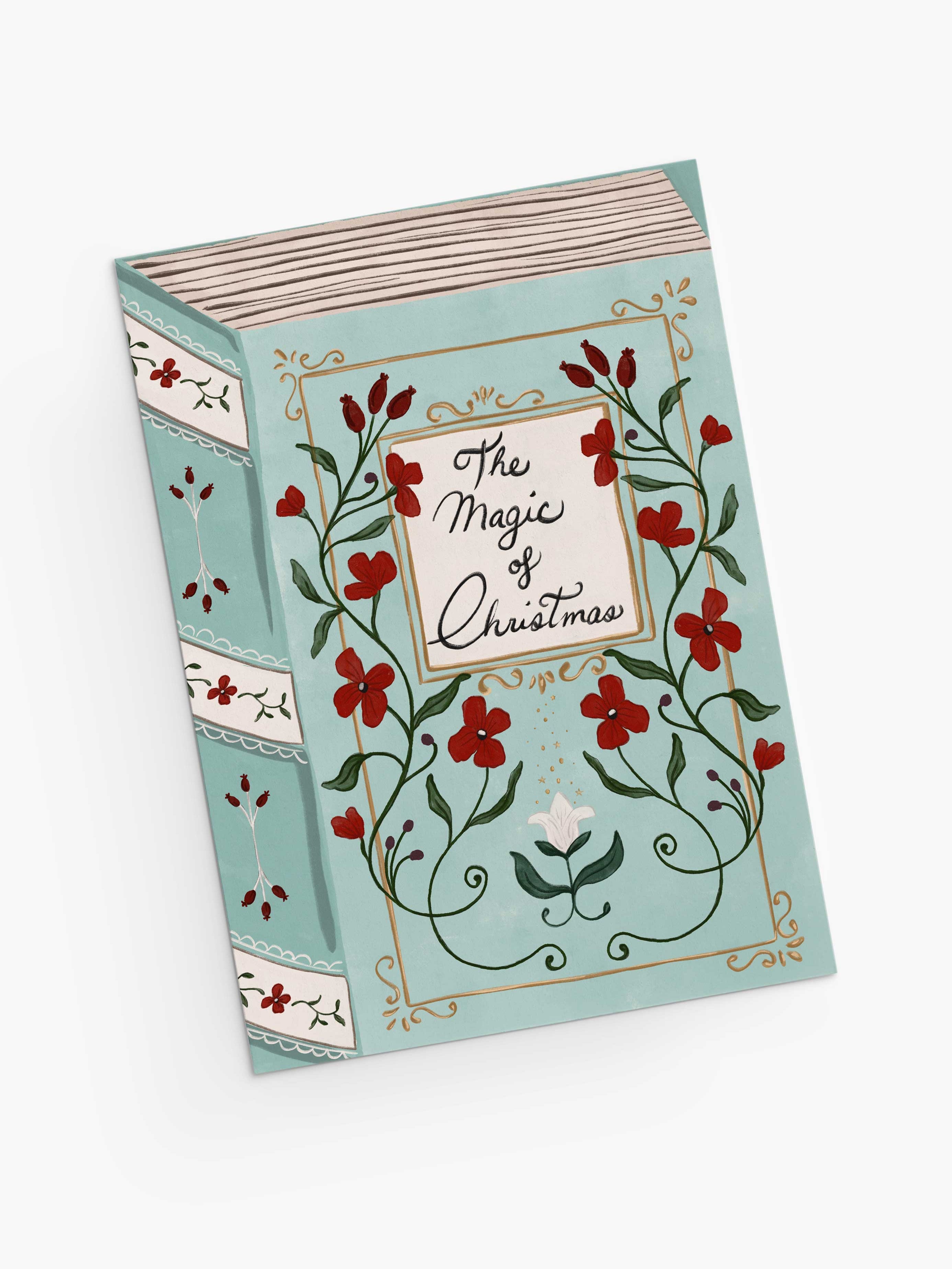 A greeting card titled "The Magic of Christmas" by Mimi & August, featuring floral and vine illustrations on a light blue cover and crafted with recycled paper.