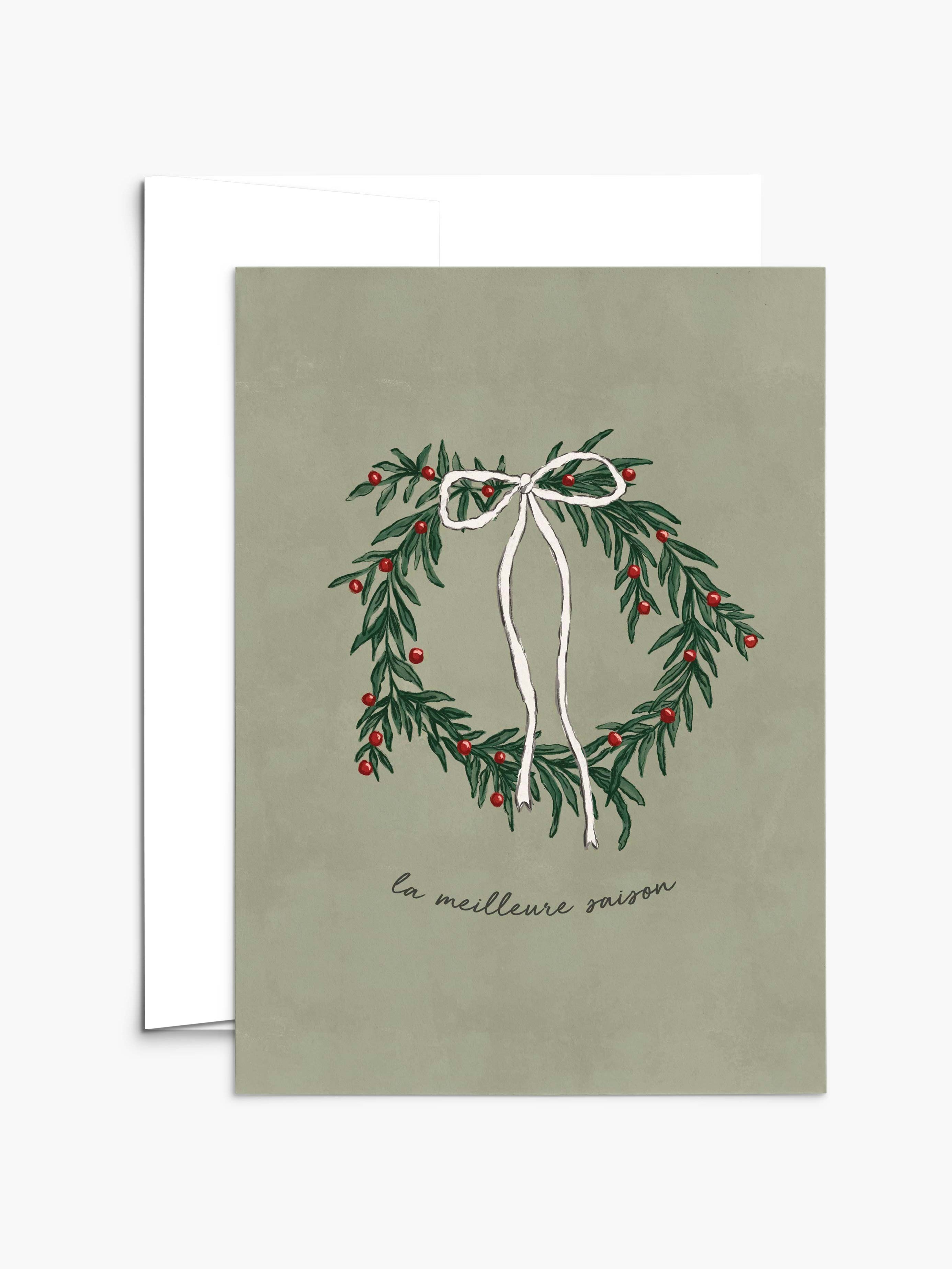 The Best Season Christmas Greeting Card by Mimi & August features an illustrated wreath with red berries and a white ribbon on green, "la meilleure saison" text, is blank inside, and printed on recycled paper.