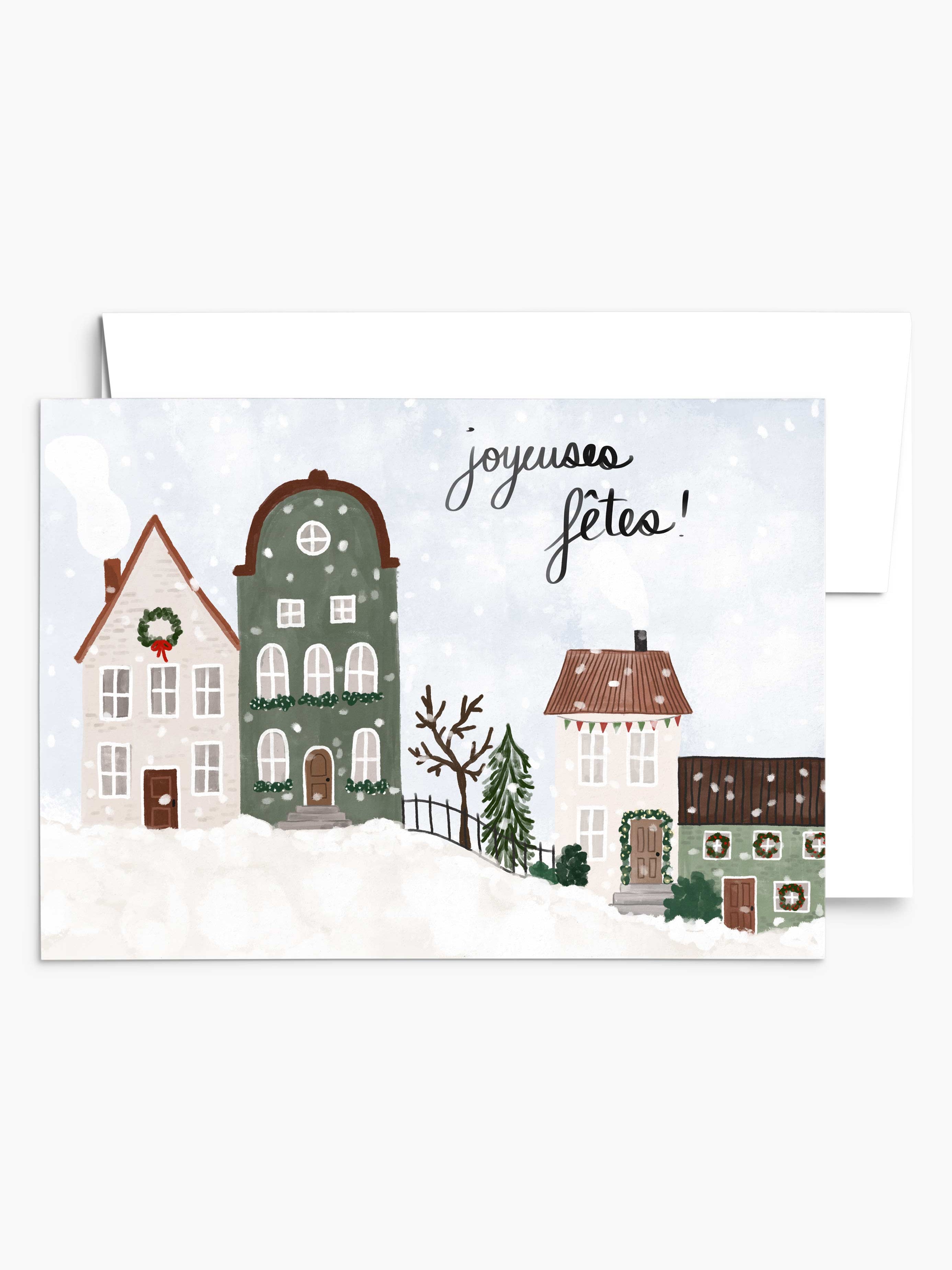 The "Warmth of the Snowy Village" Christmas greeting card by Mimi & August showcases snowy houses with "Joyeuses Fêtes!" elegantly scripted above, crafted on recycled paper.