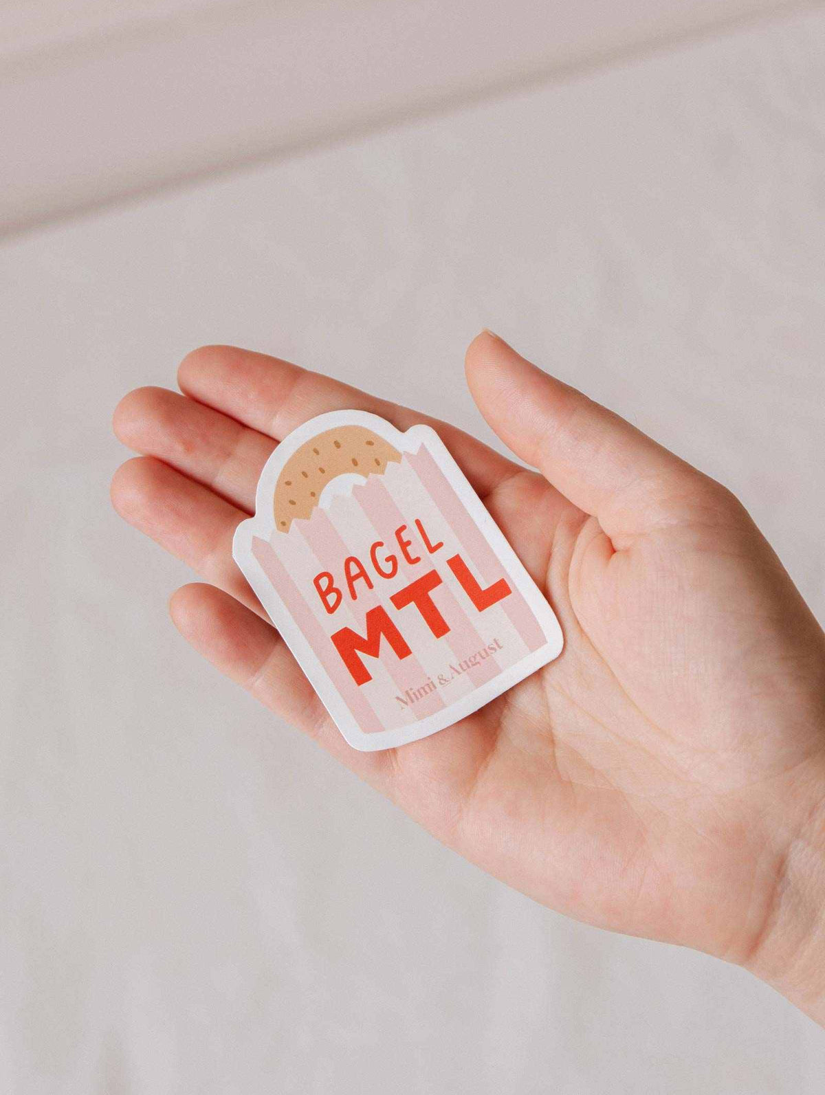 Bagel MTL vinyl sticker with playful Montréal bagel design, durable and weatherproof.