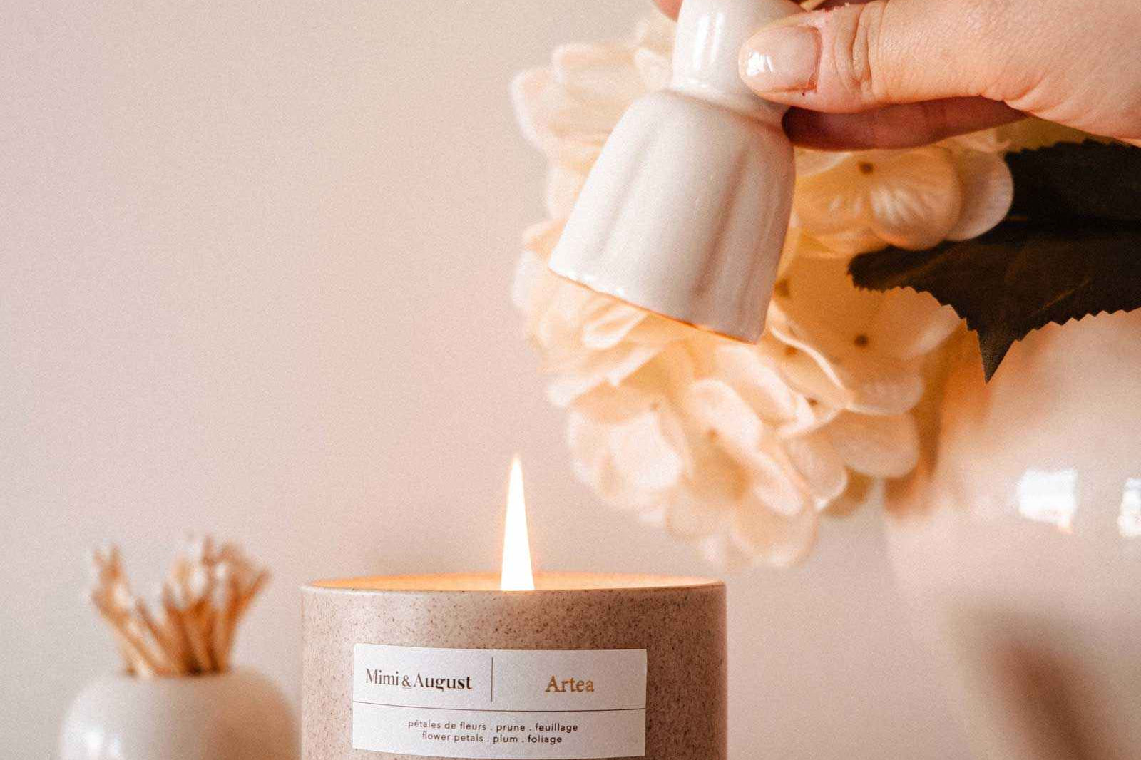 Handmade ceramic candle snuffer extinguishing candle flame with elegant minimalist design