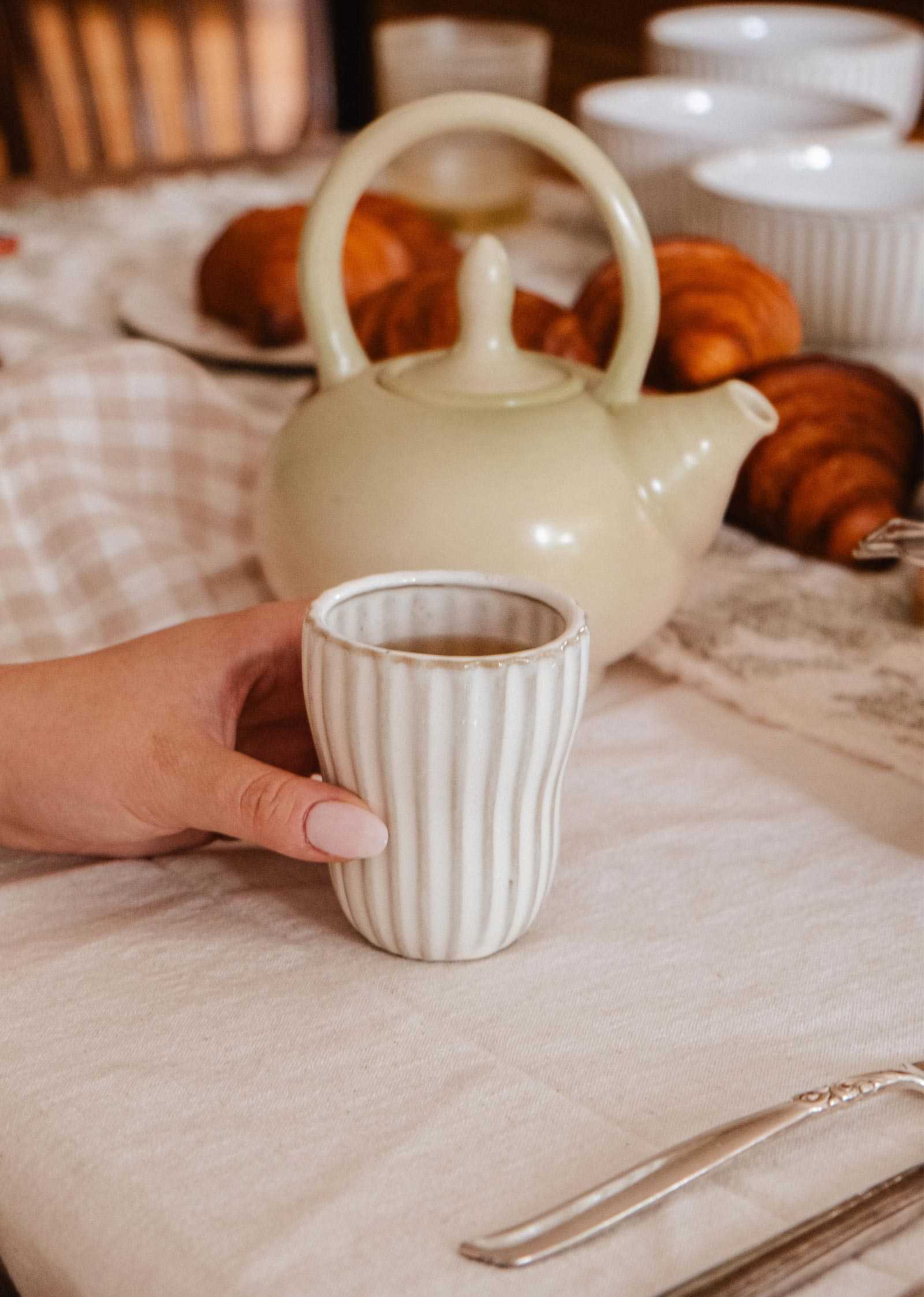 Handmade ceramic espresso cup with ribbed detailing and soft cream glaze